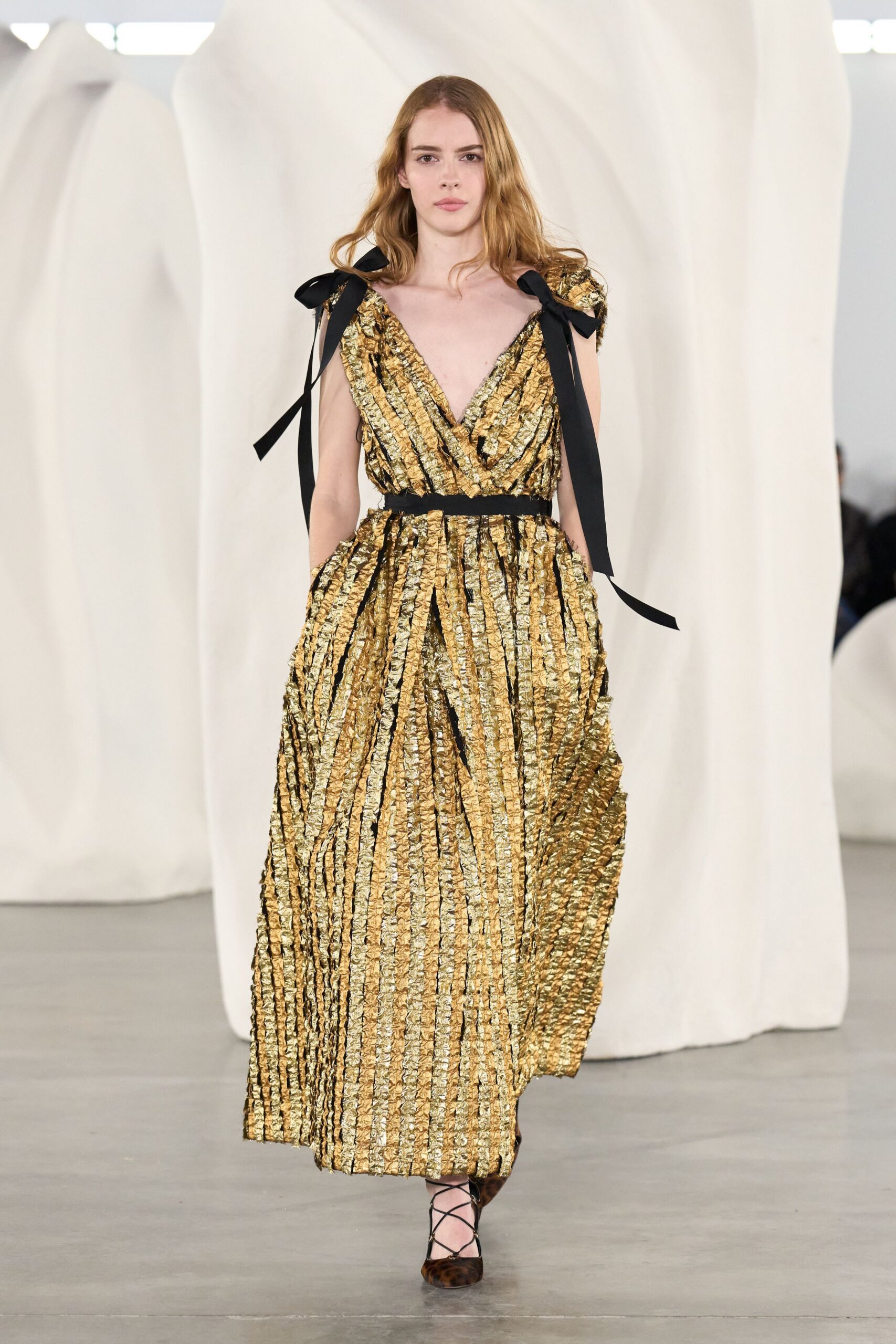 gold silk sleeveless v-neck fitted pleated belted gown