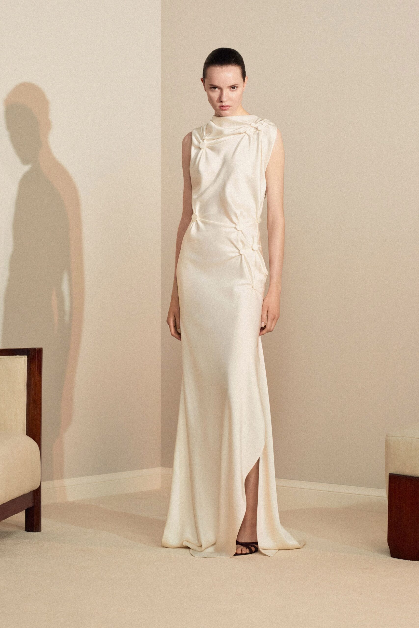 ivory silk sleeveless high-neck fitted draped flowing gown