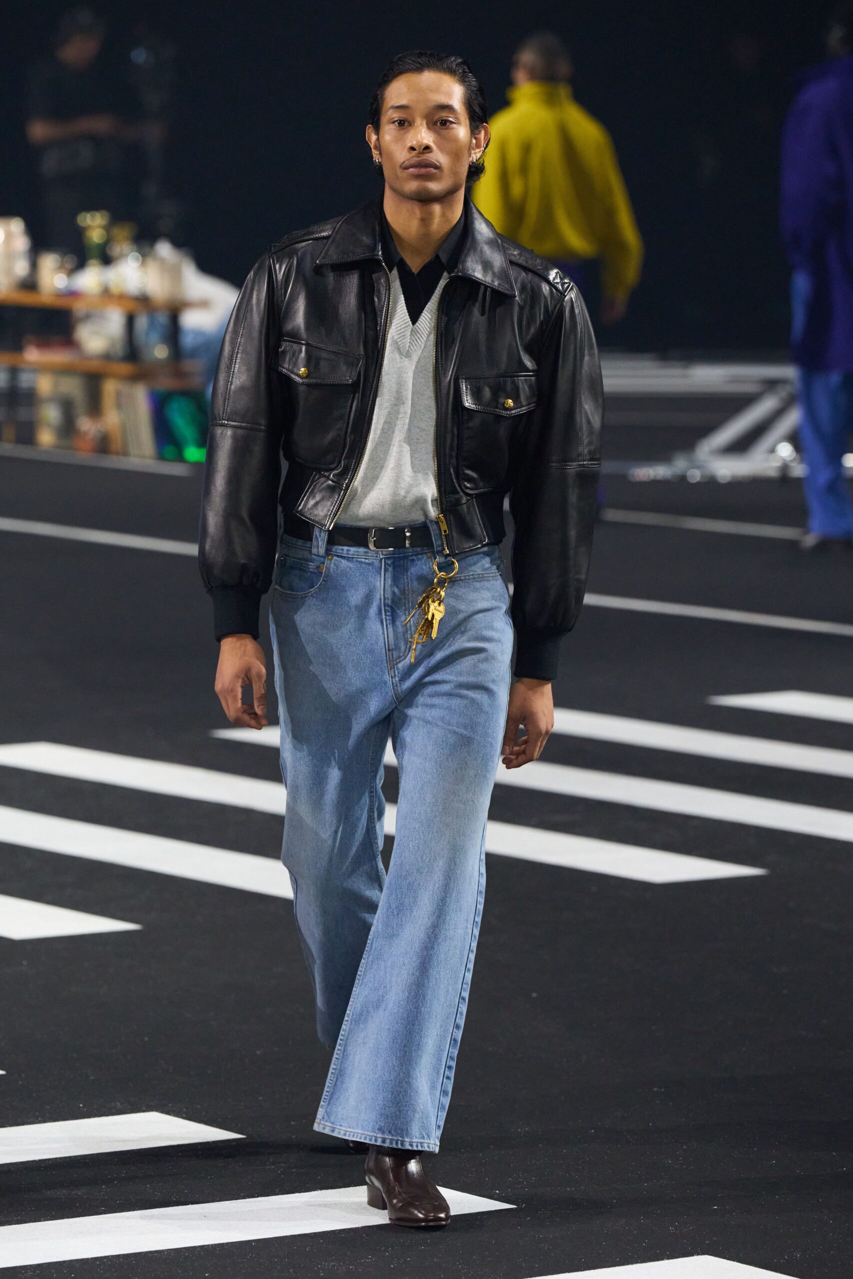 black leather jacket gray shirt blue pants