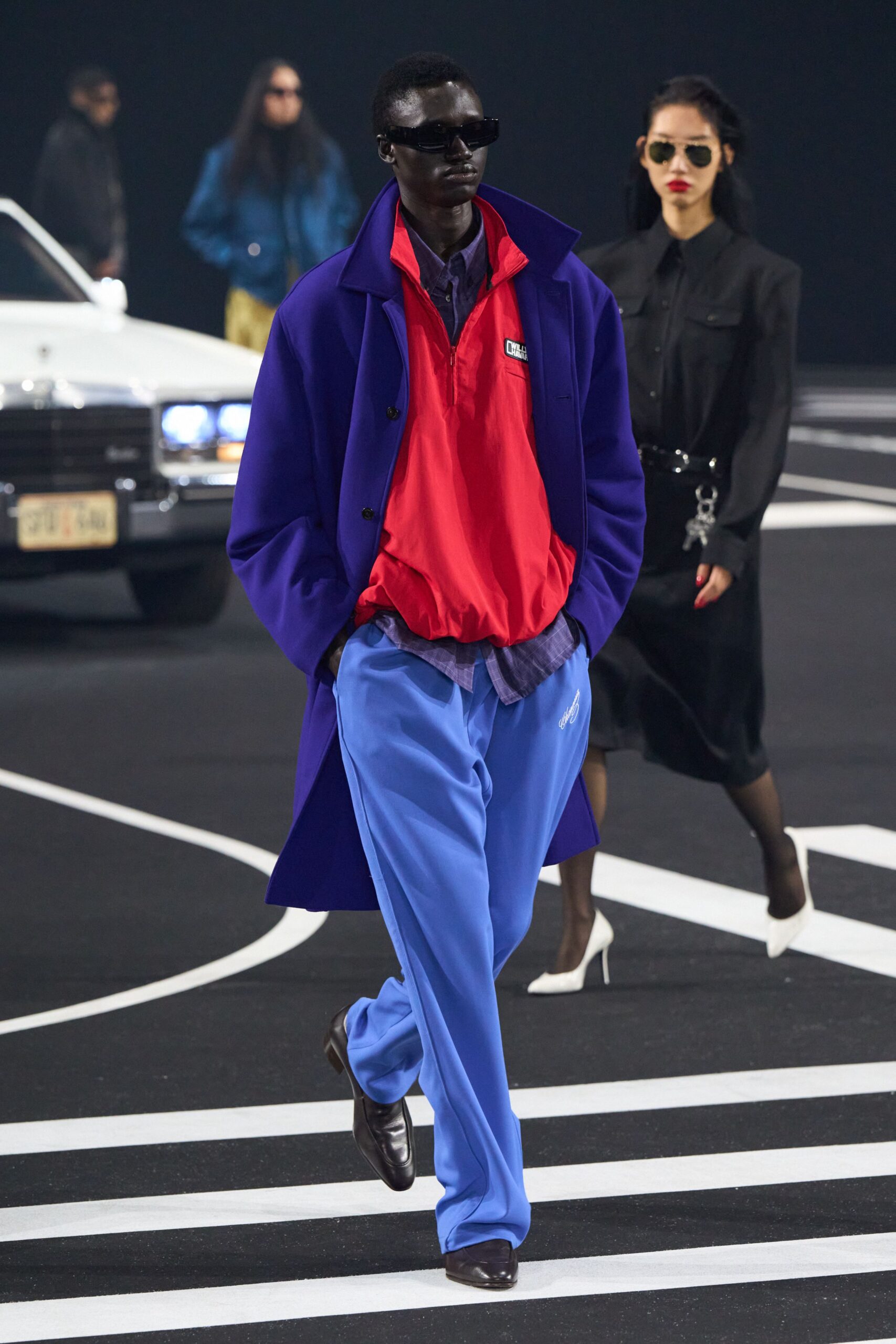 blue coat red top relaxed pants