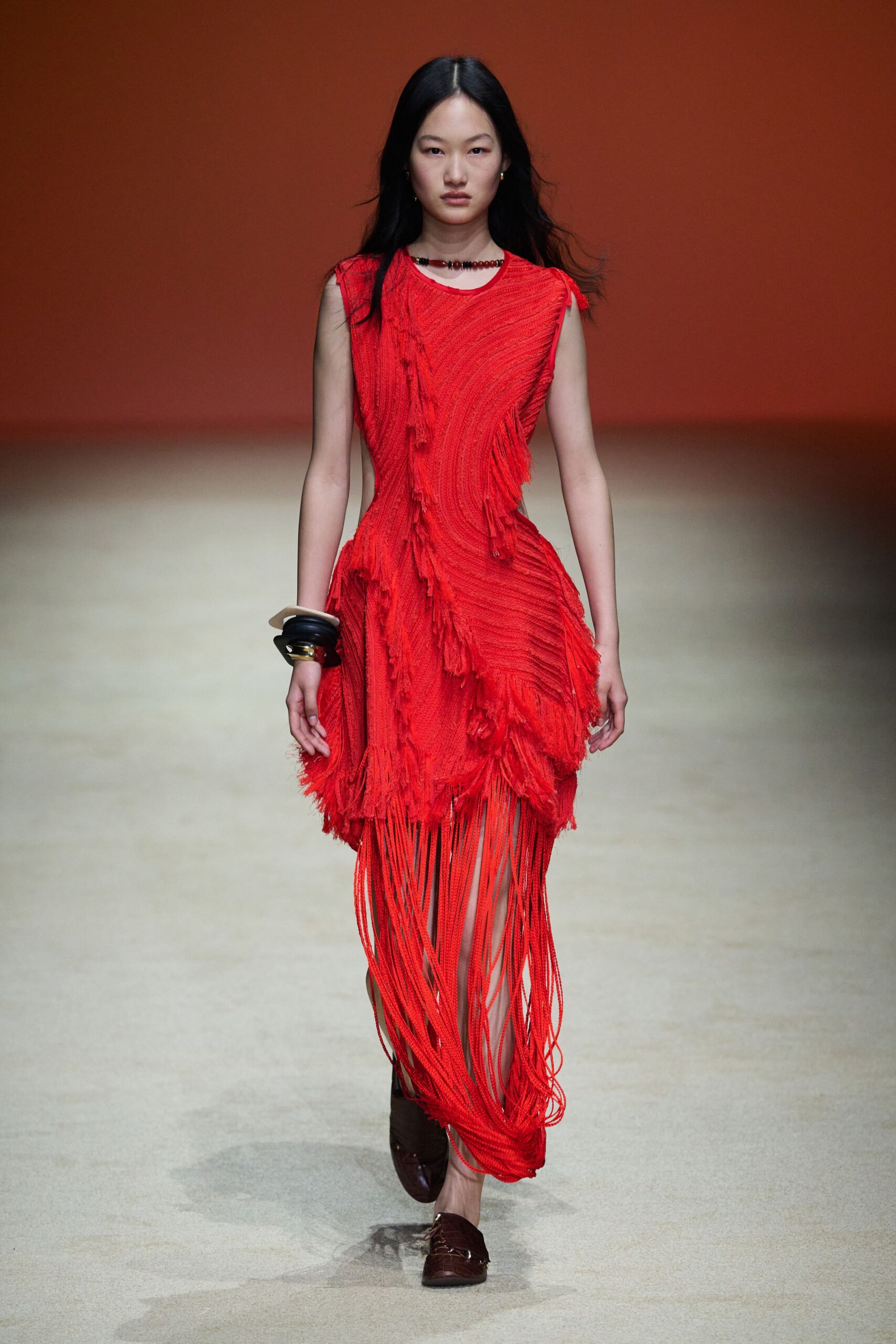 red silk sleeveless v-neck fitted fringed draped dress