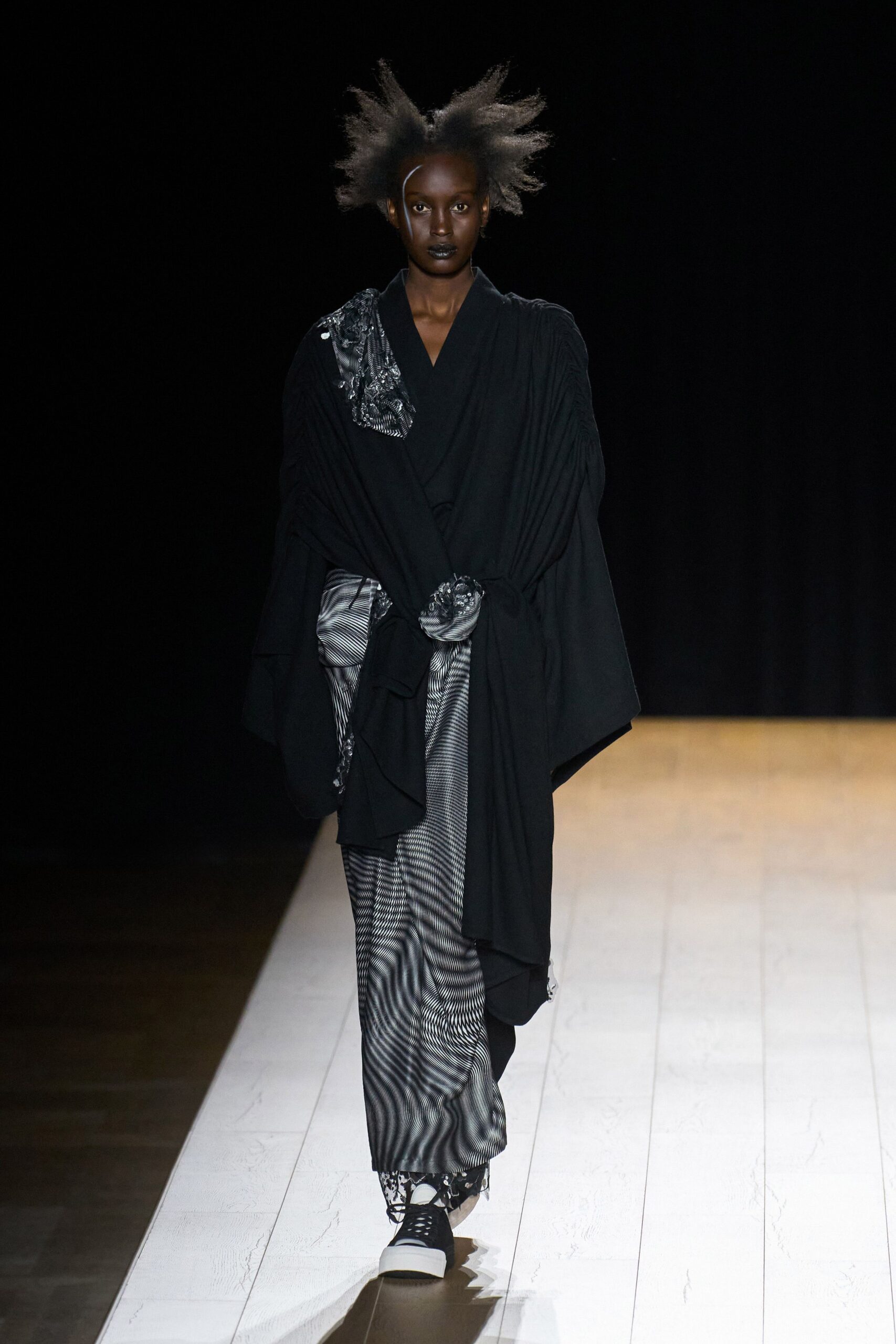 black layered coat and pleated skirt