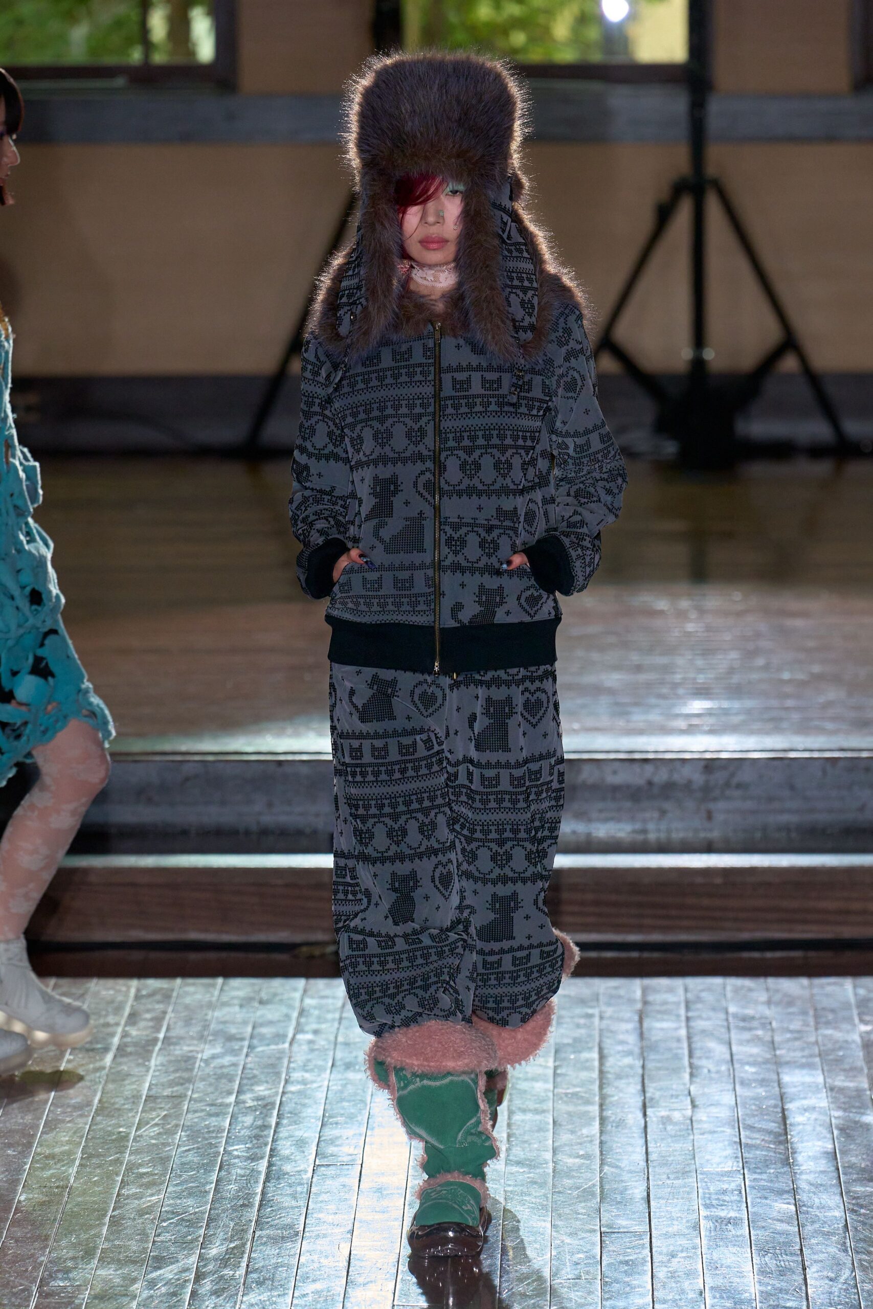 black printed faux-fur coat with green pants