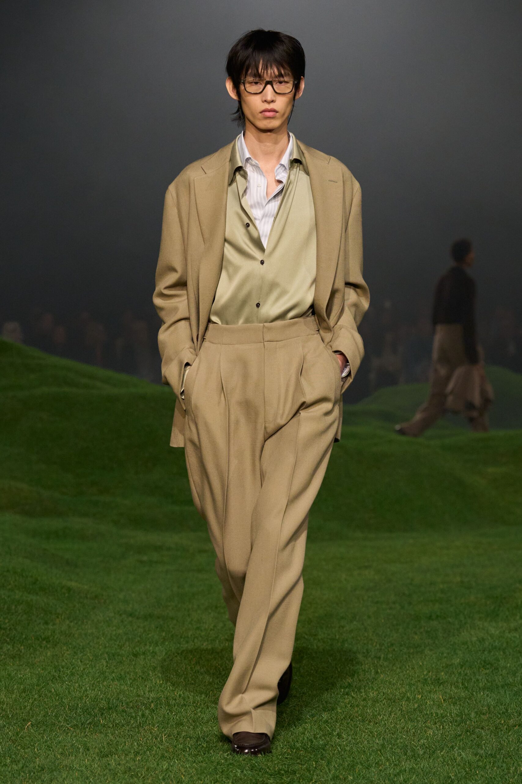 beige tailored suit with green shirt