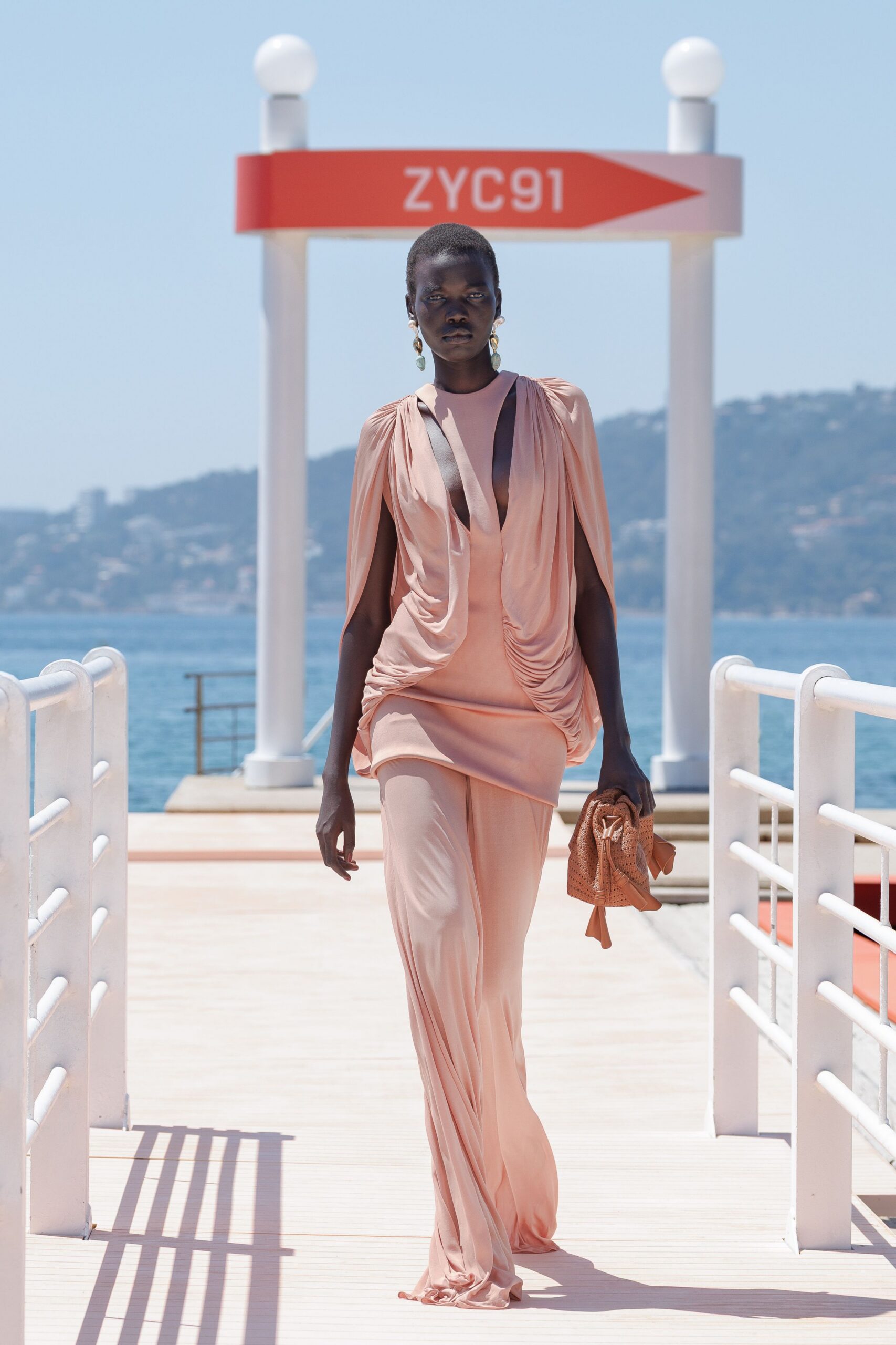 coral silk sleeveless v-neck fitted draped flowing gown