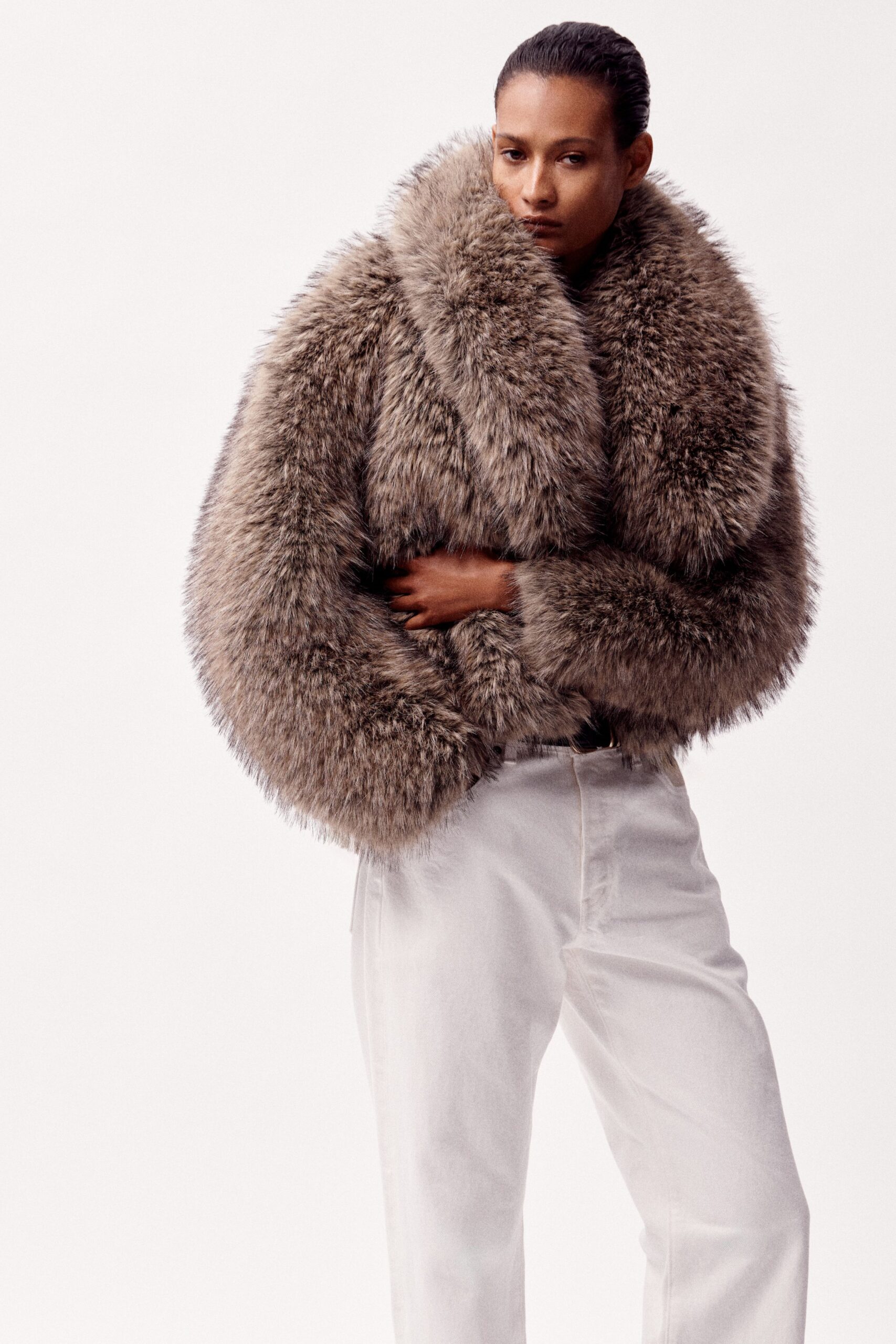 brown fur coat and white pants