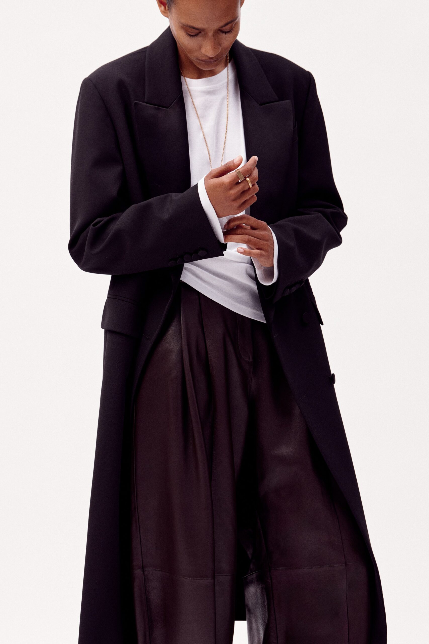 black coat white shirt leather pants