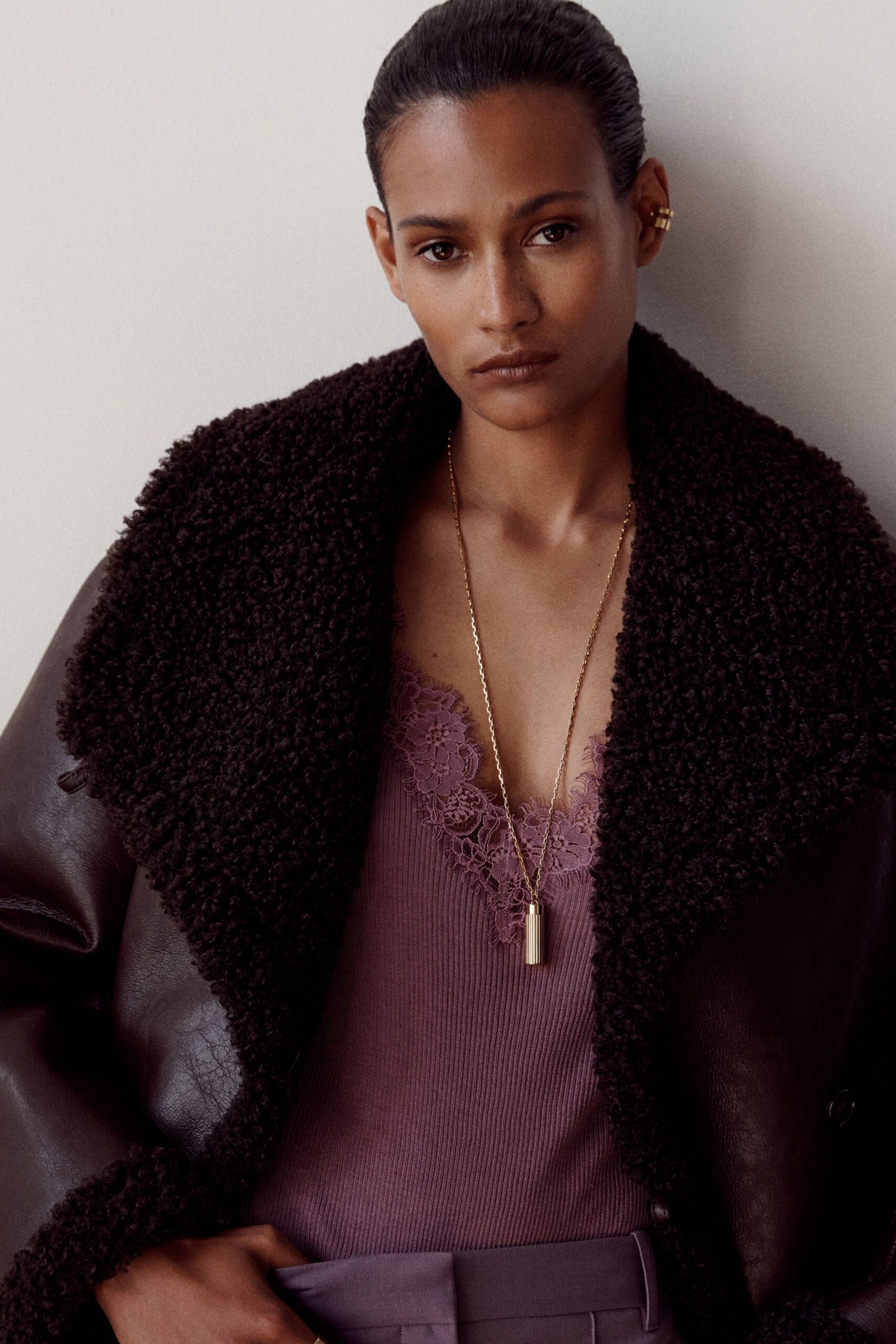 brown leather oversized coat and purple top