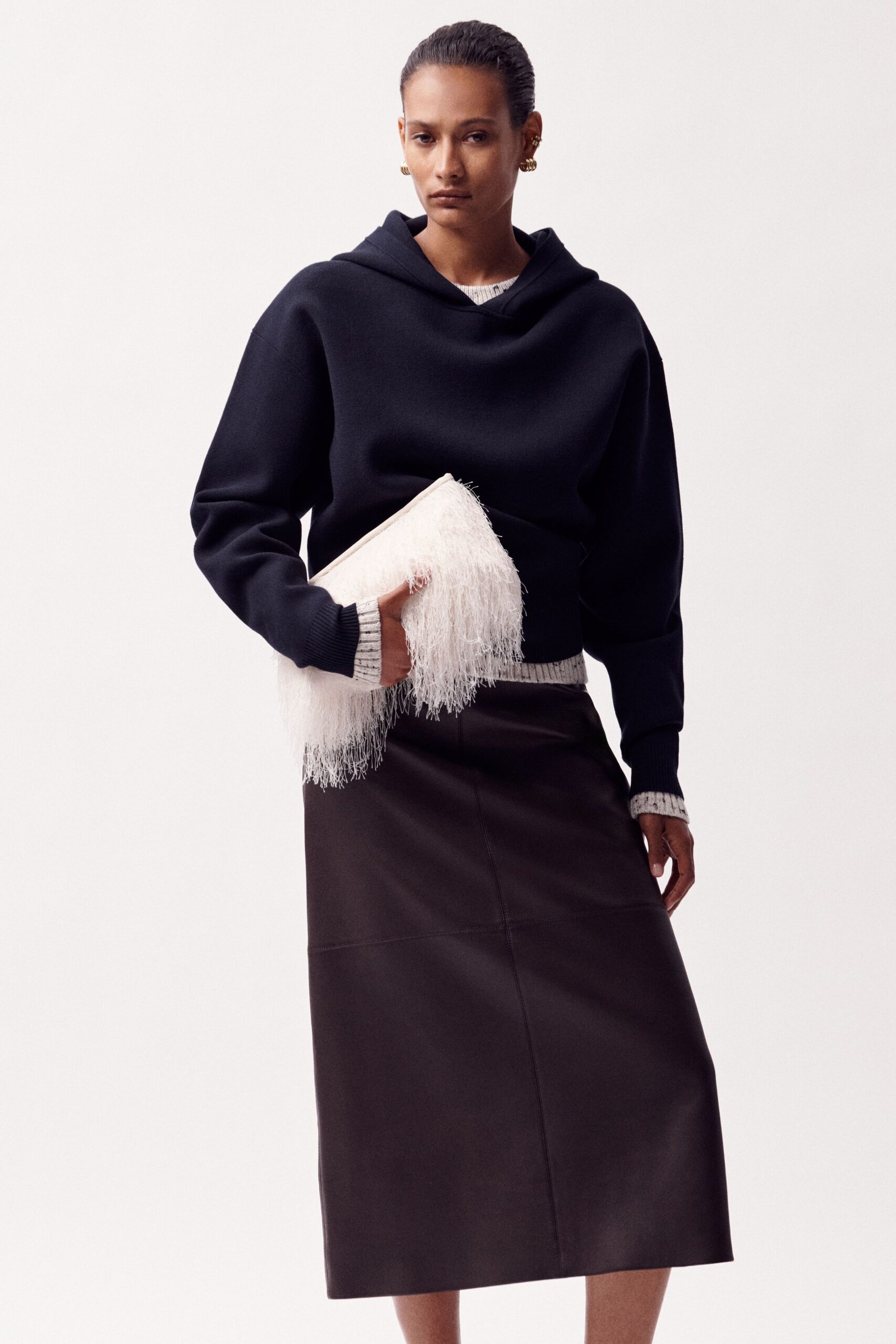 black hoodie and leather midi skirt
