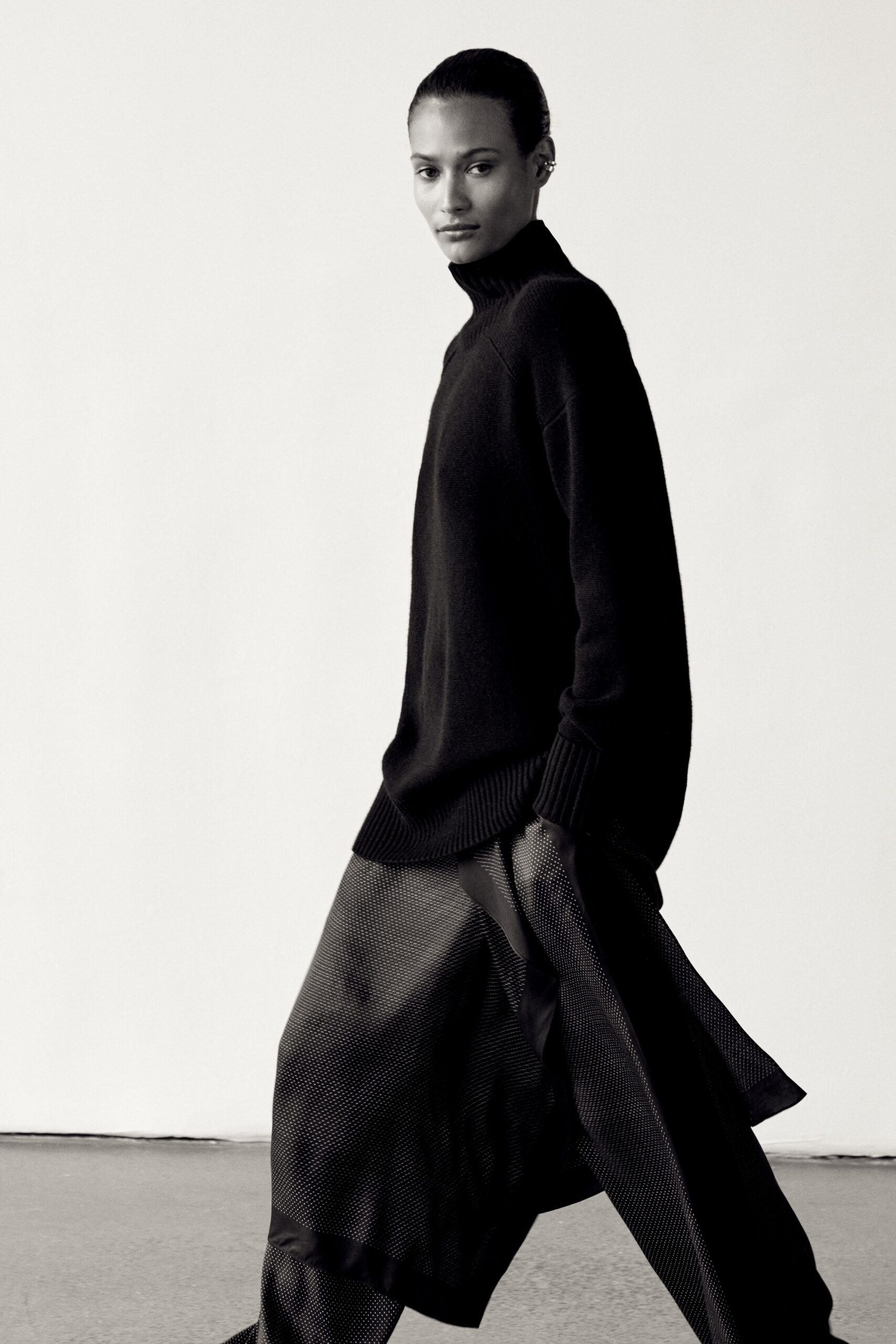black relaxed sweater with pleated skirt