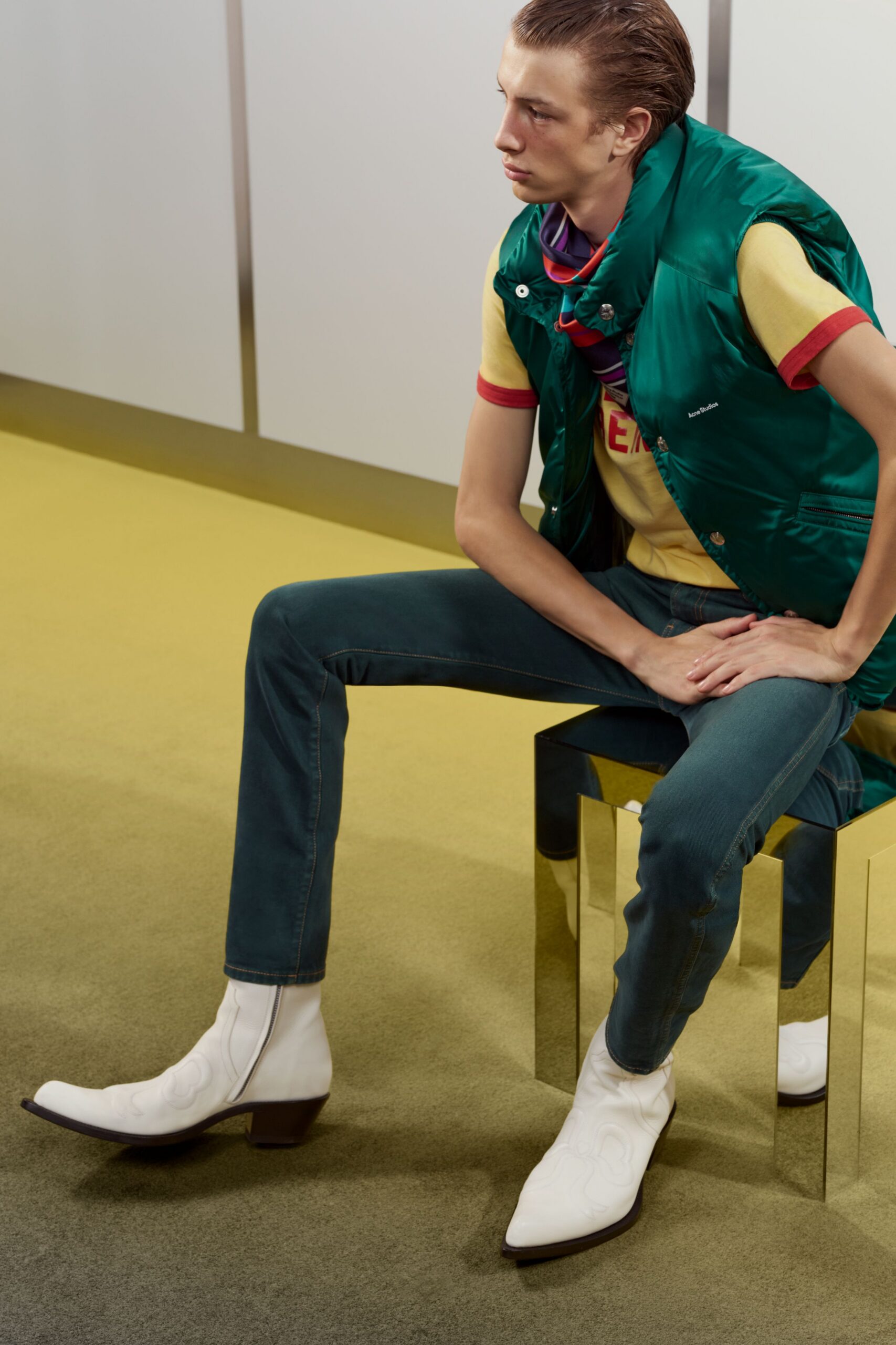 green vest yellow t-shirt blue pants white boots