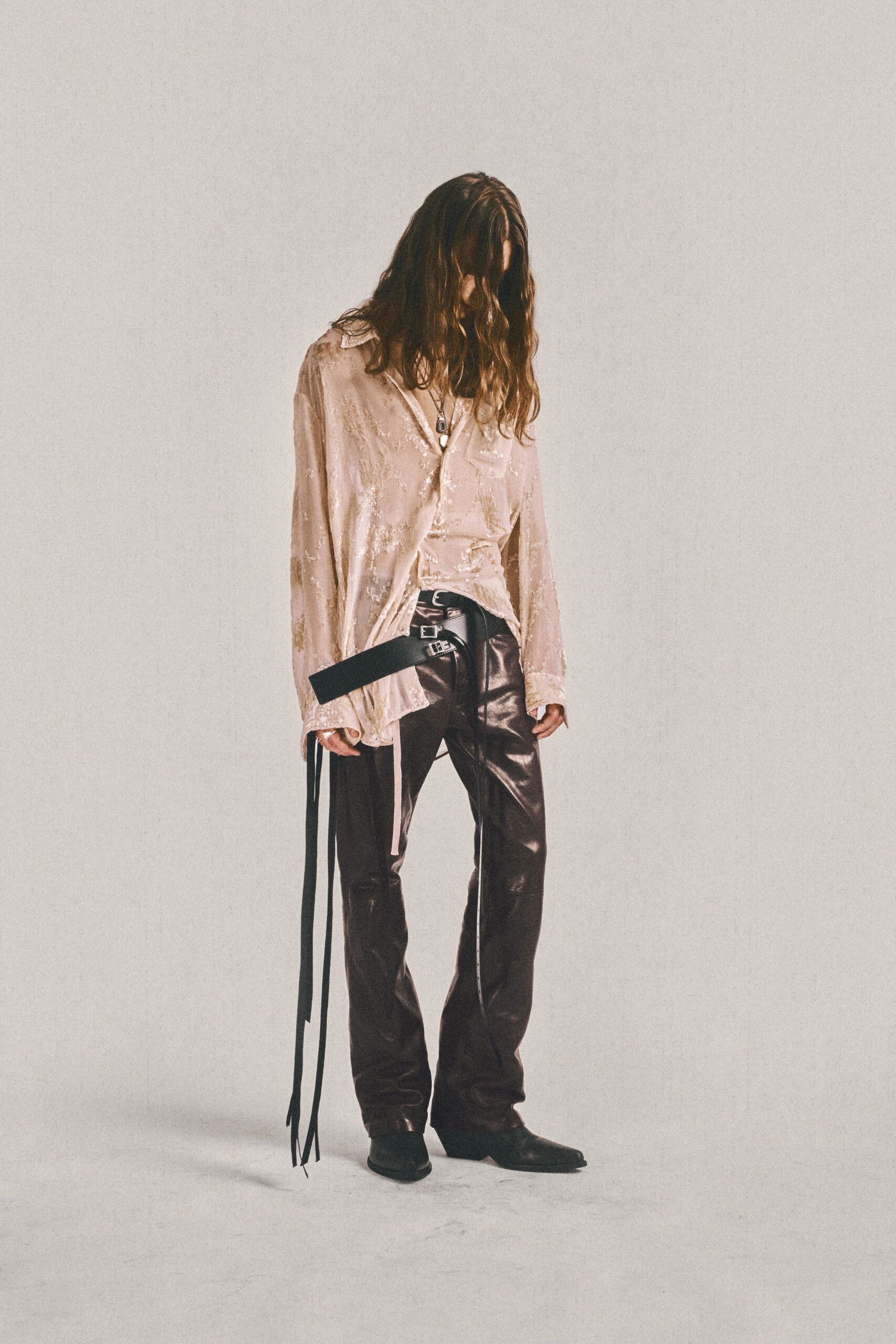 pink silk shirt and brown leather pants