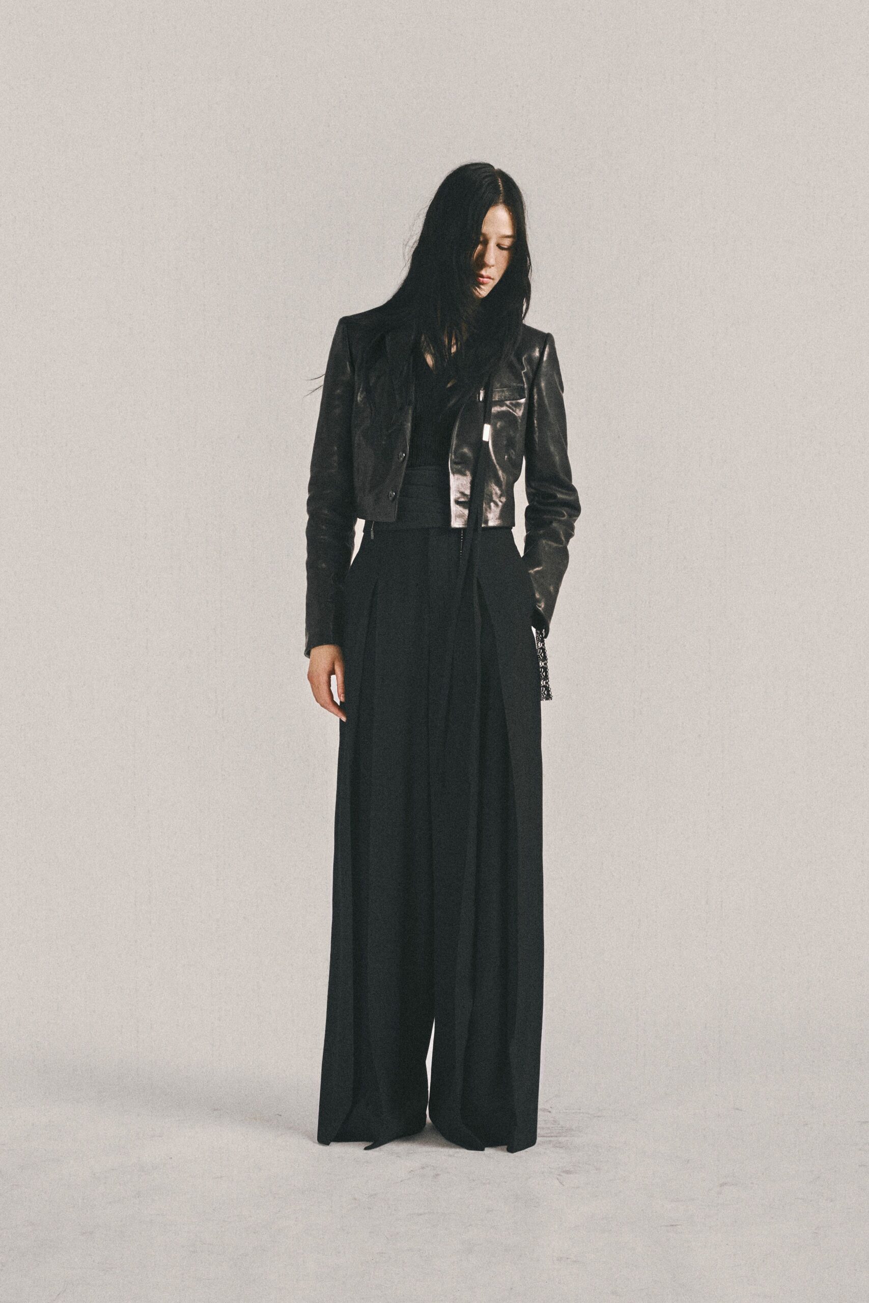 black leather fitted jacket and relaxed pants