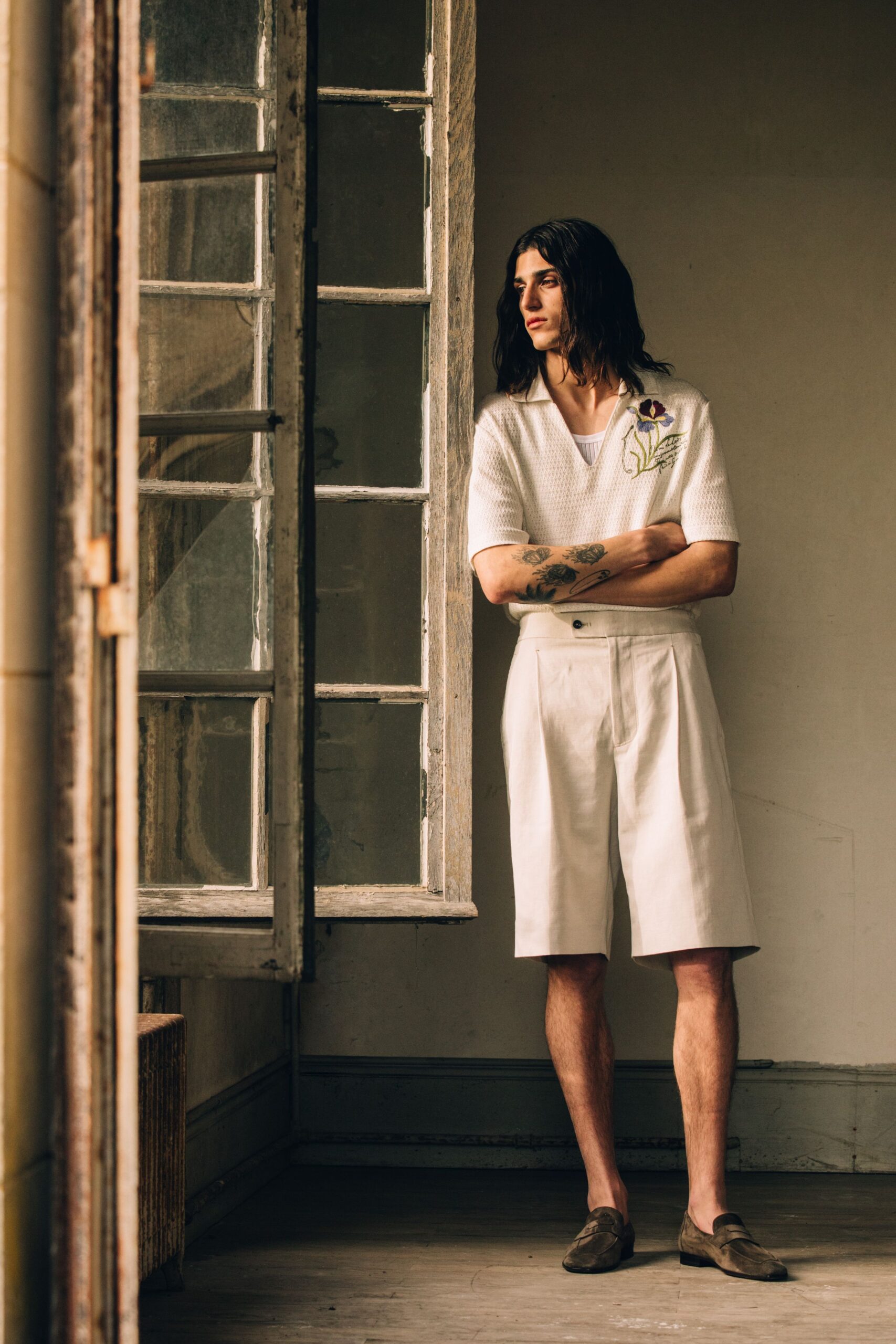 white relaxed shirt with beige shorts