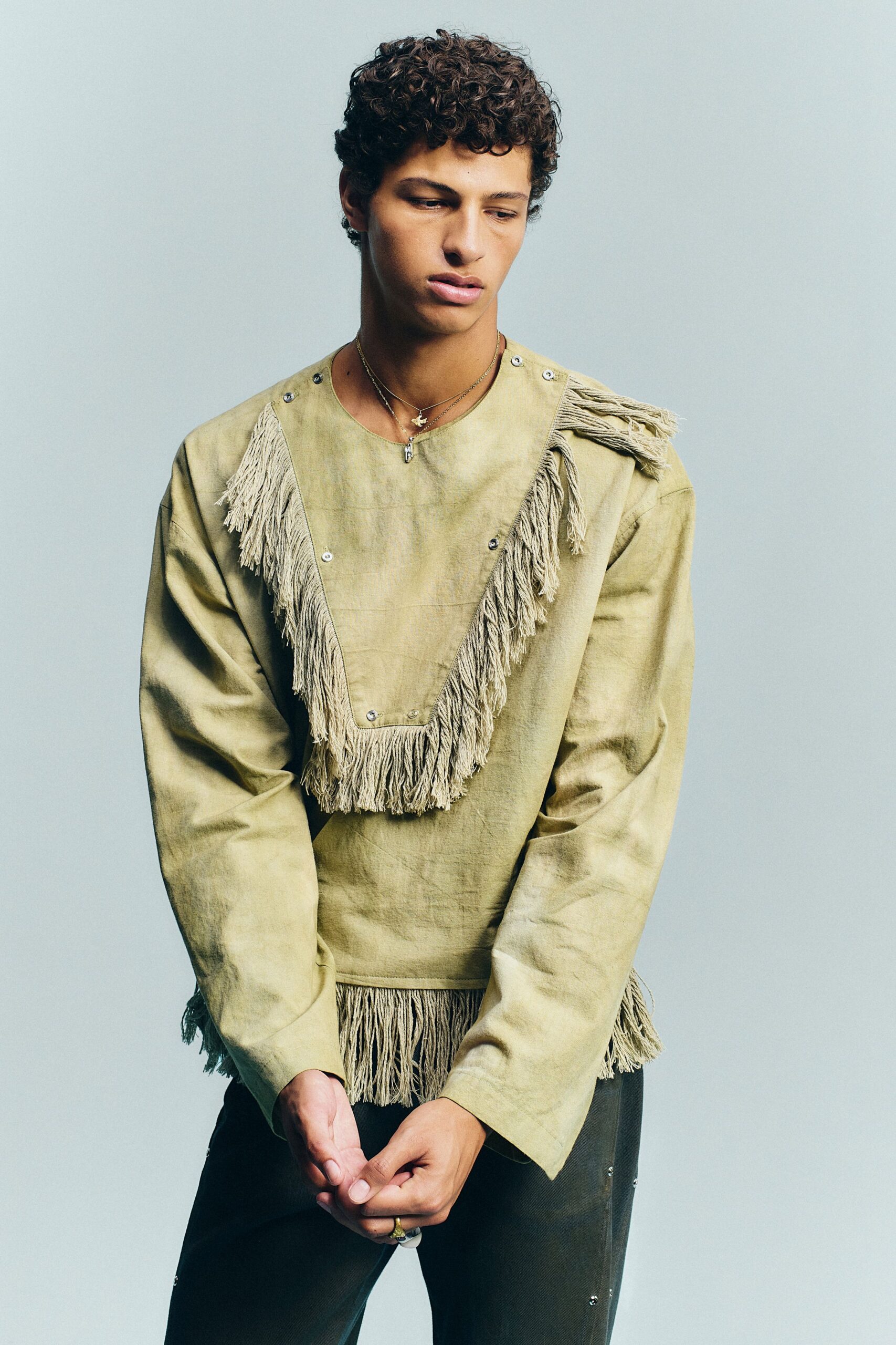 beige fringed top with black pants