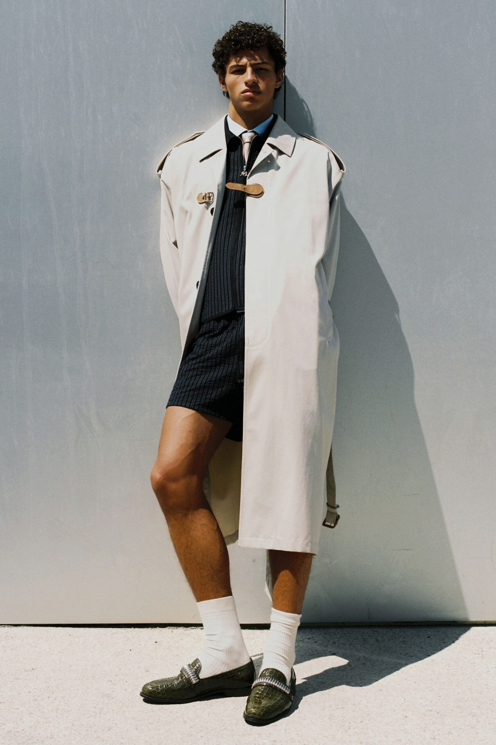 beige trench coat with black shorts