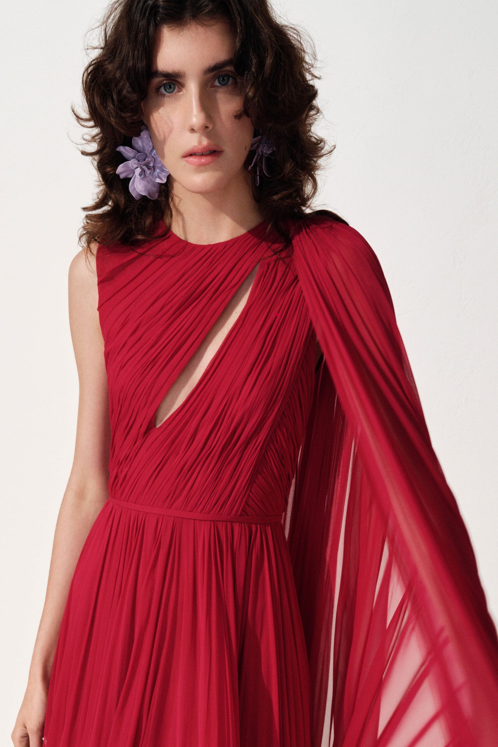 red pleated flowing gown