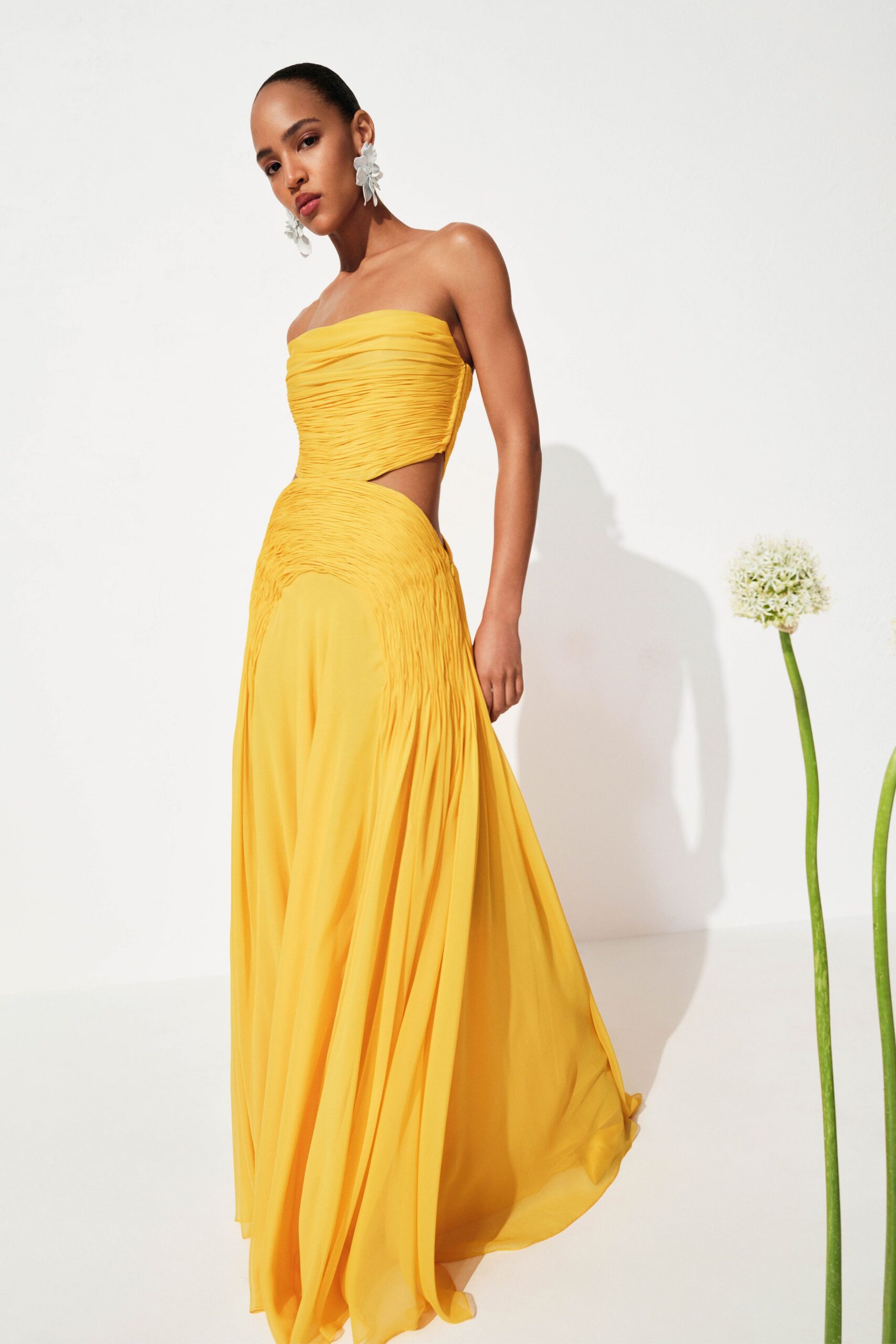 yellow strapless flowing gown