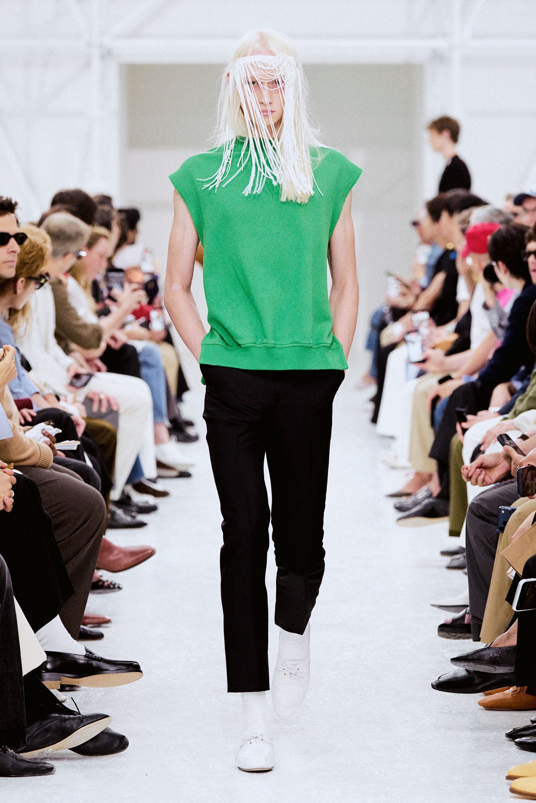 green sleeveless top with black pants