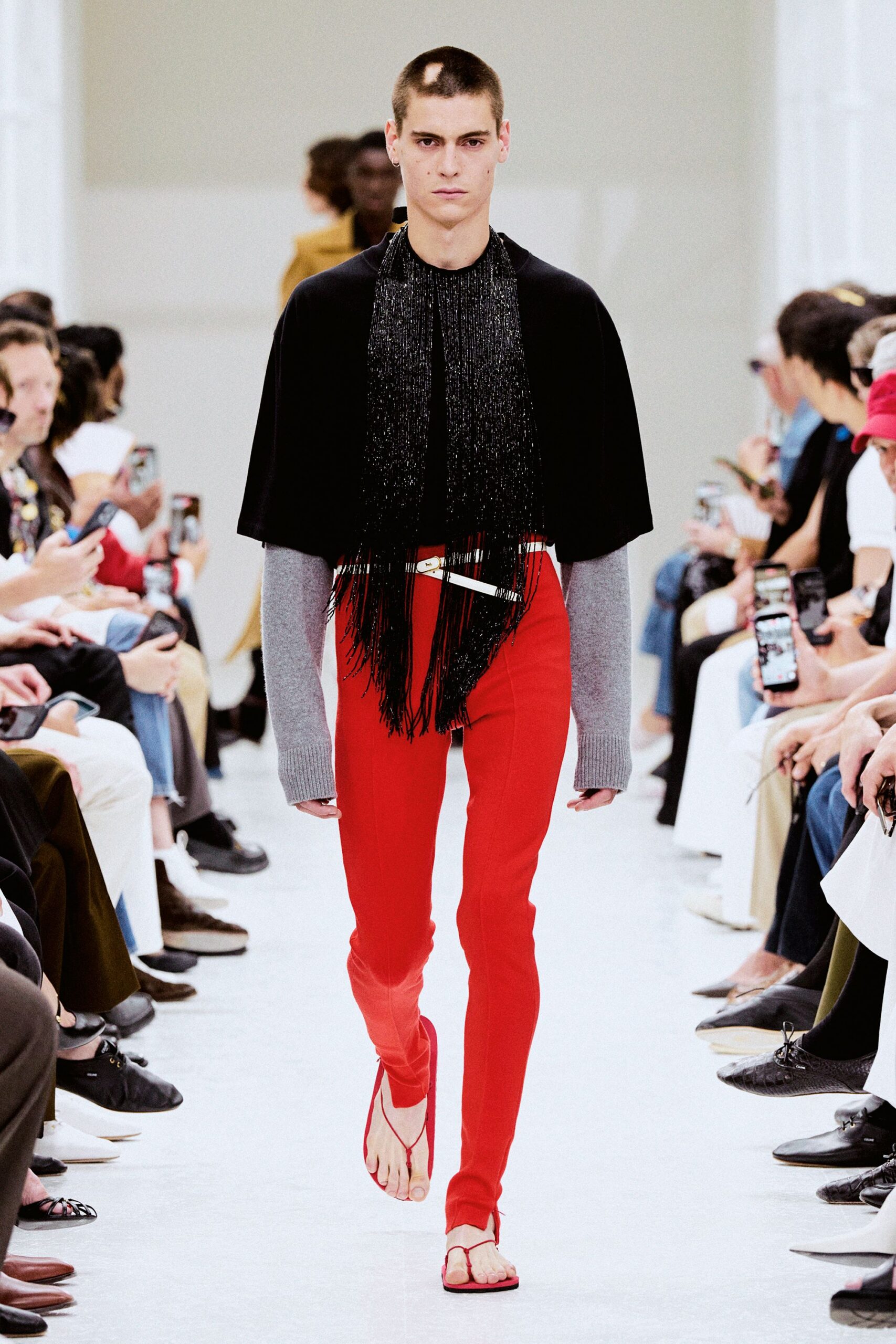 black cape gray sweater red pants