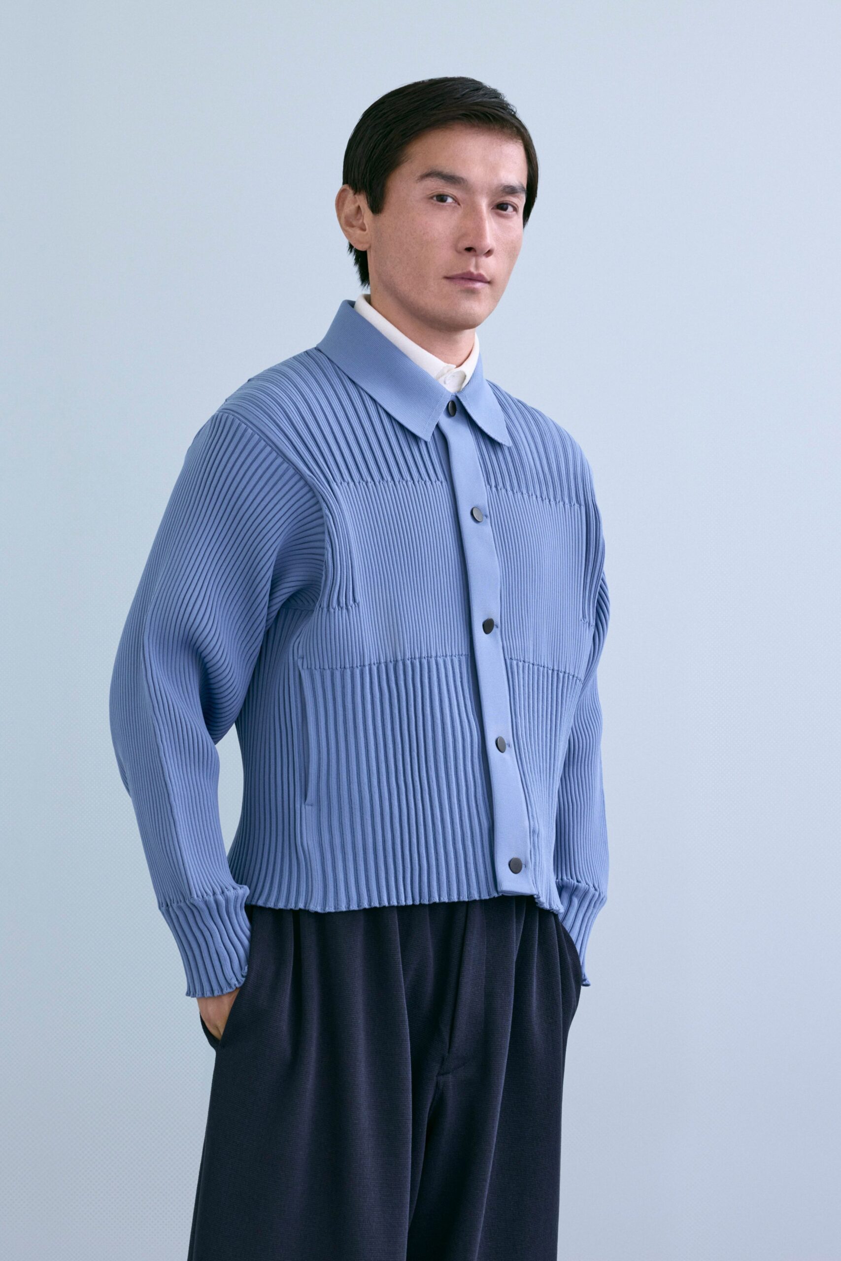 blue pleated shirt and black pants