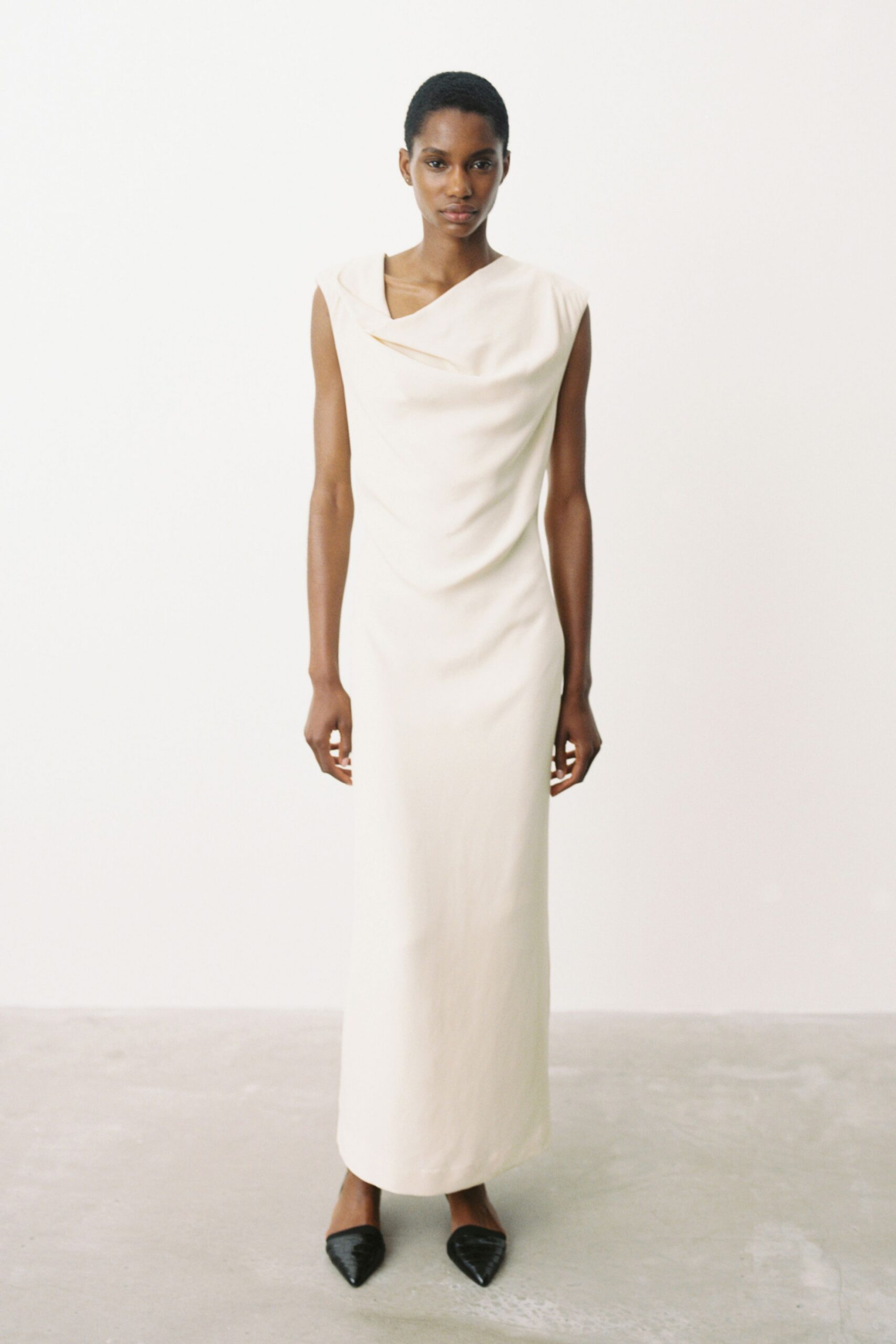 beige silk sleeveless high-neck fitted draped maxi gown