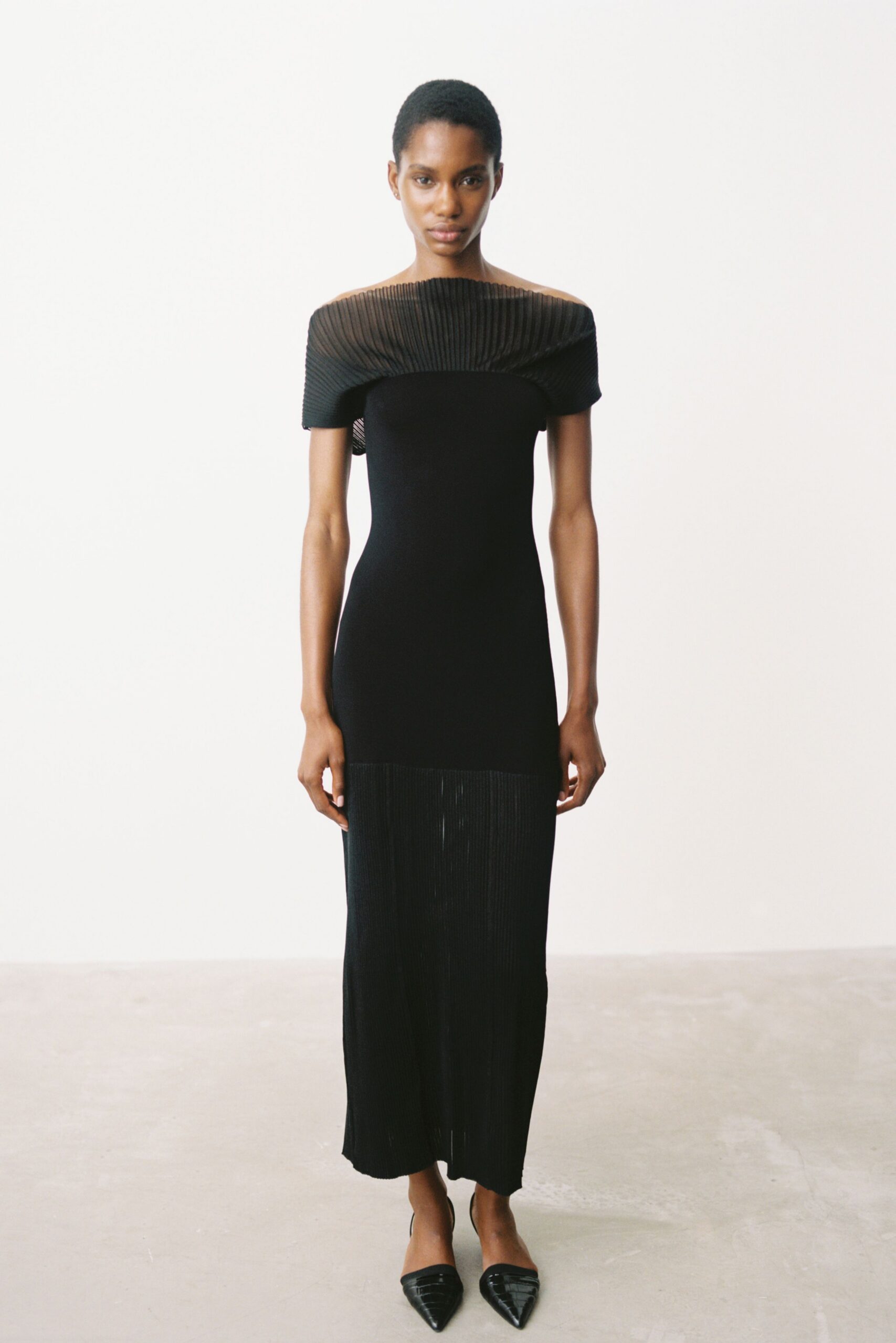 black knit sleeveless off-shoulder fitted pleated sheer dress