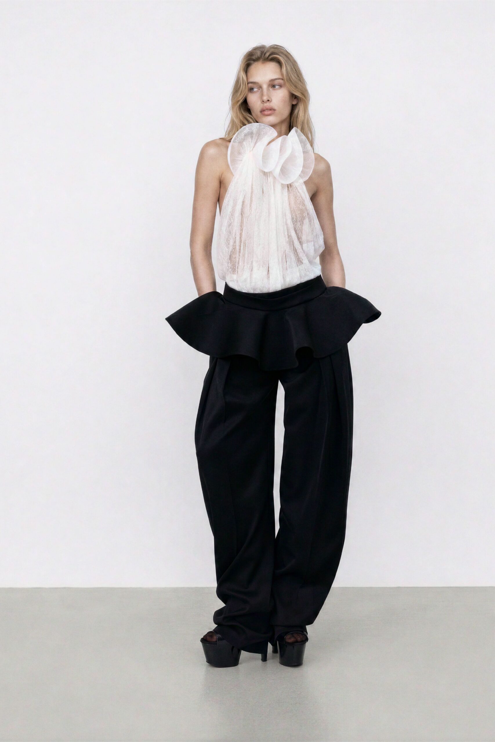 white pleated top with black pants