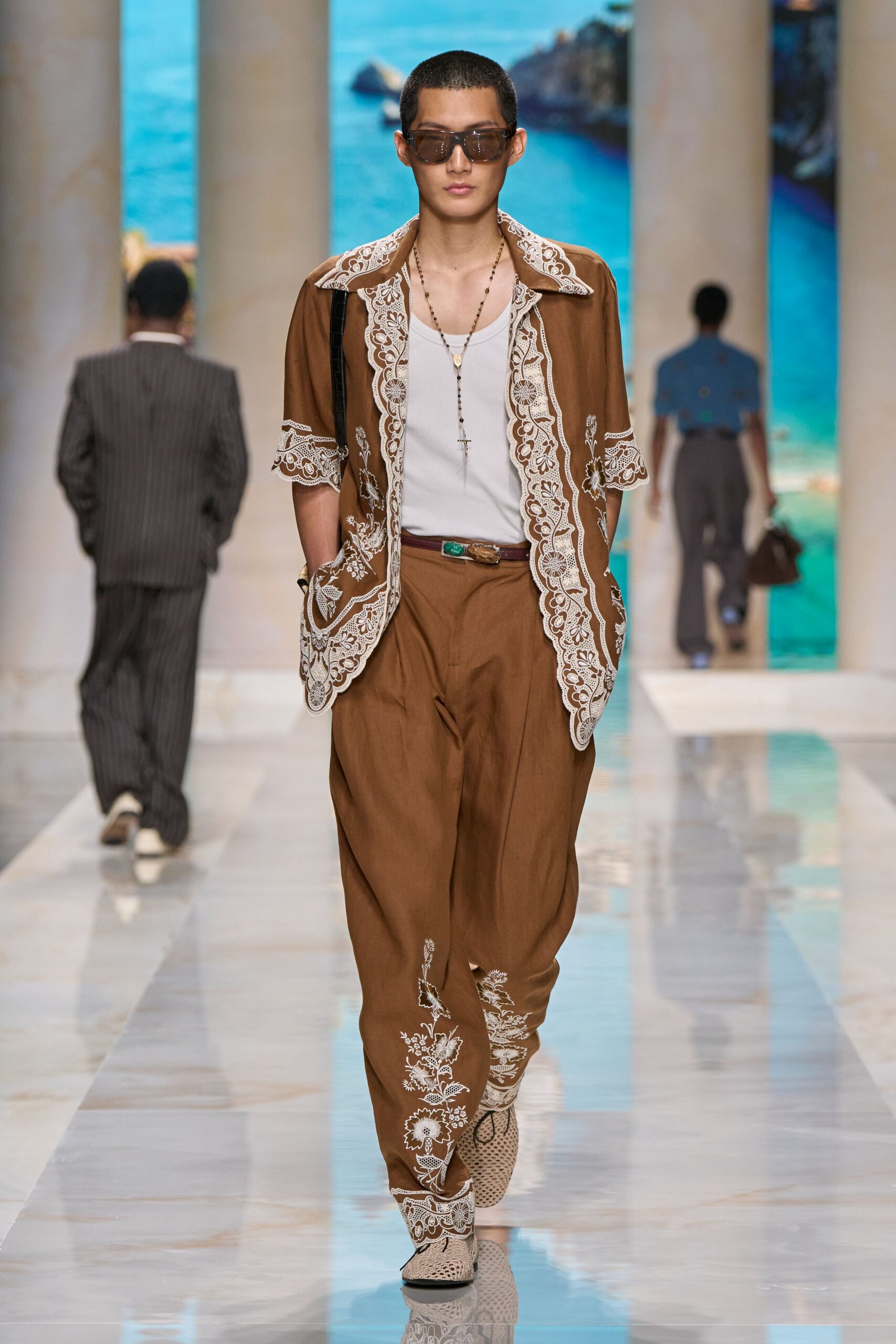 white sleeveless shirt brown pants
