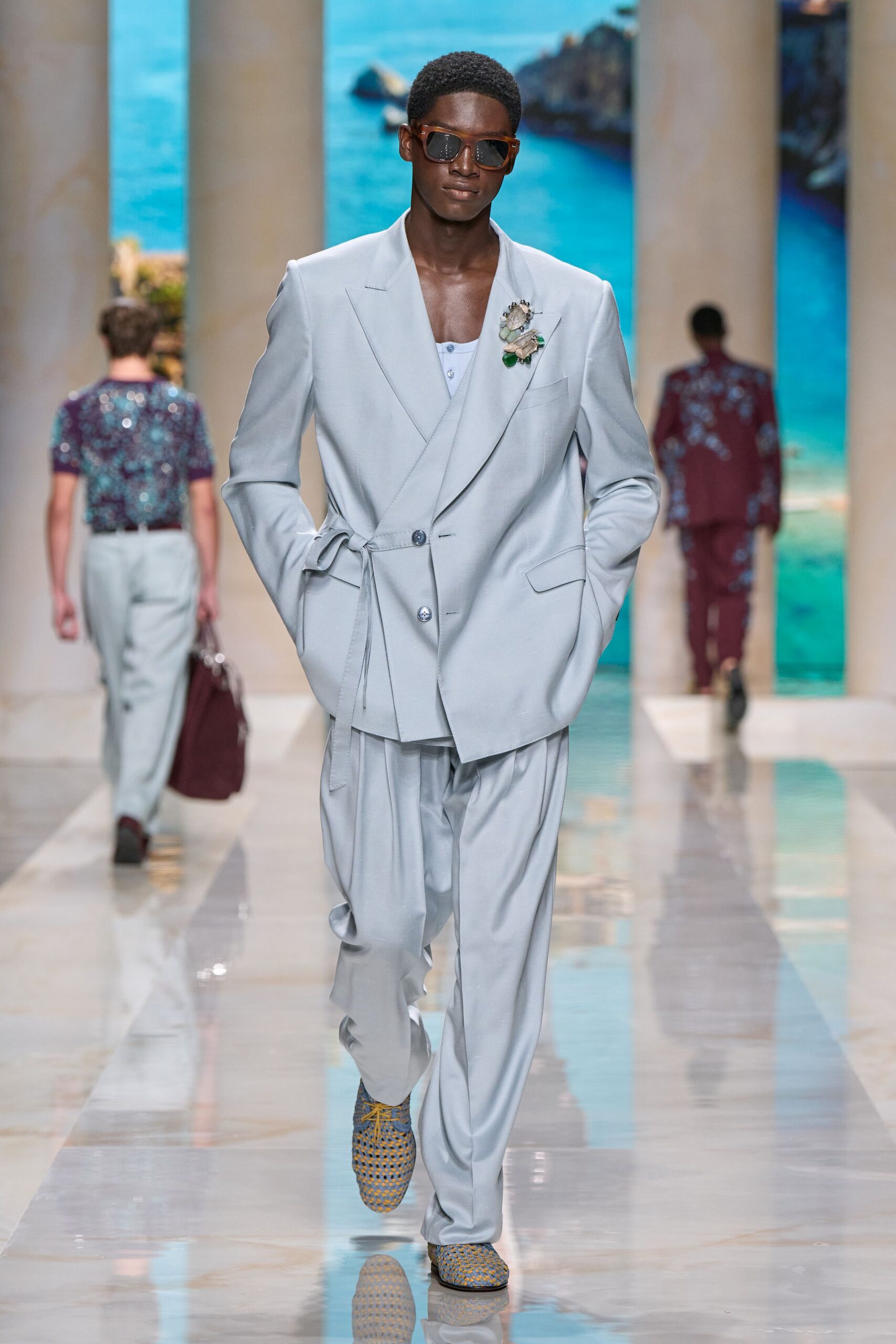light gray tailored suit with sunglasses