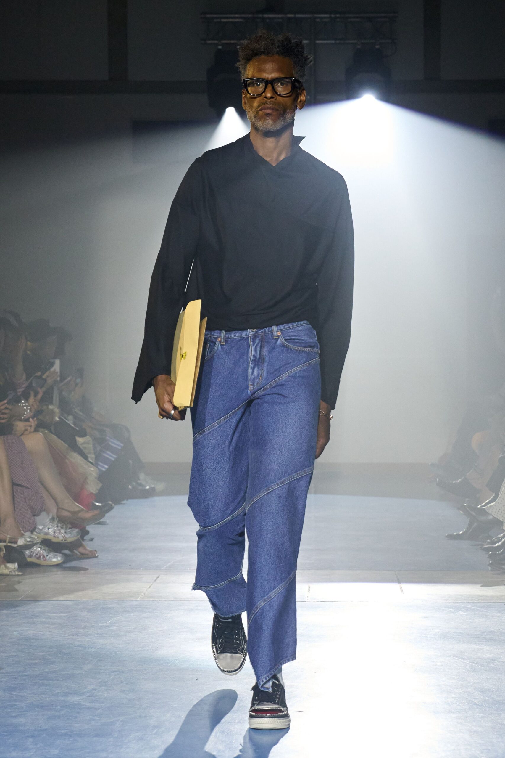 black relaxed top with blue denim pants