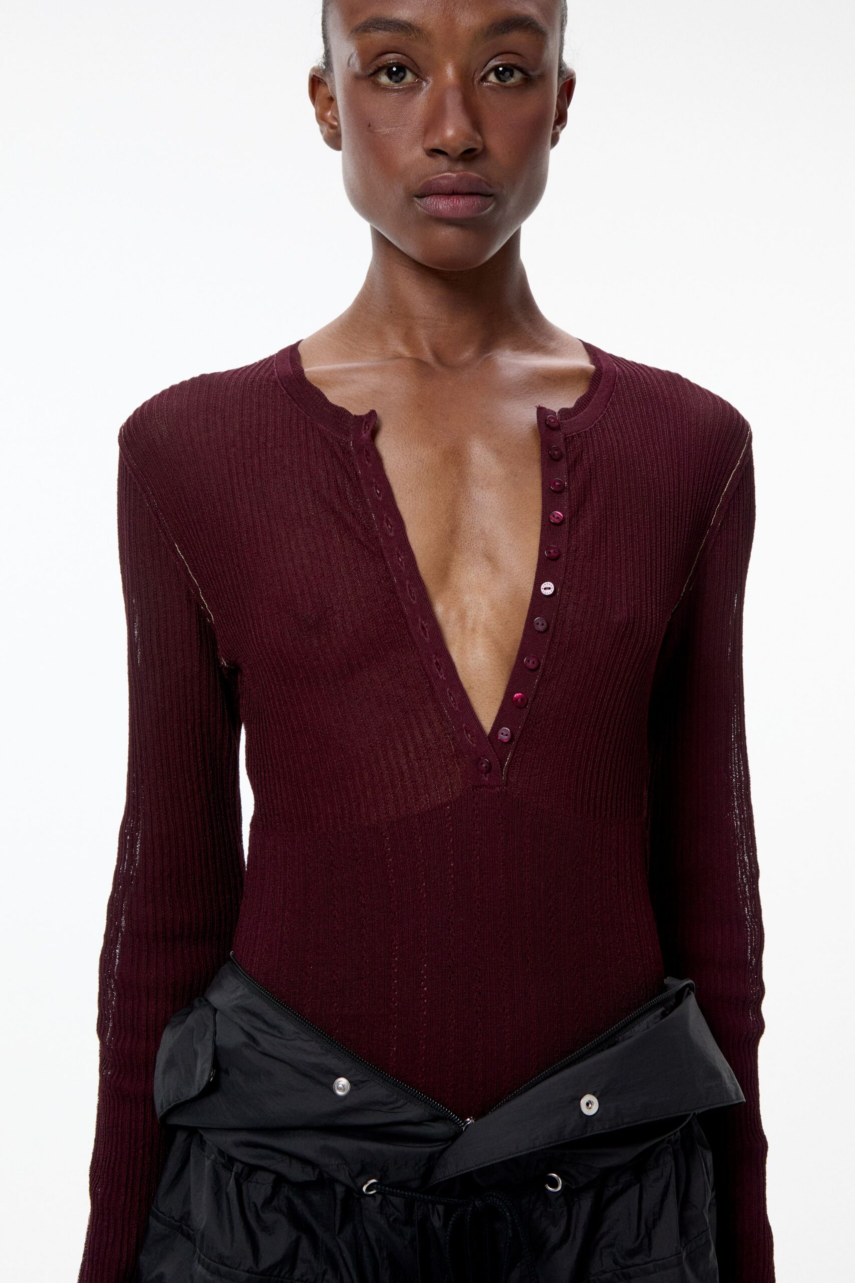 maroon fitted bodysuit with black pants