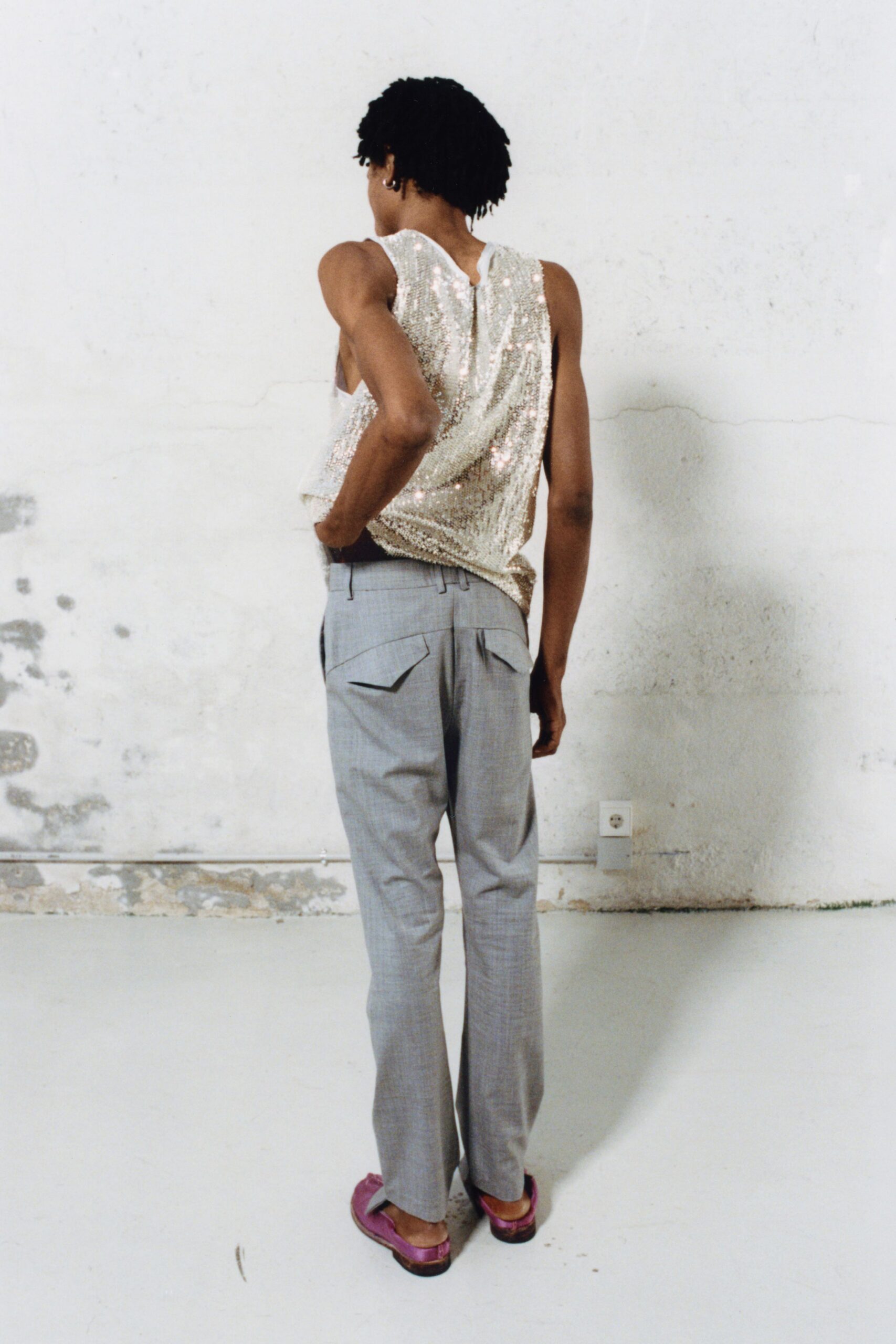 silver sequin sleeveless top with gray tailored pants