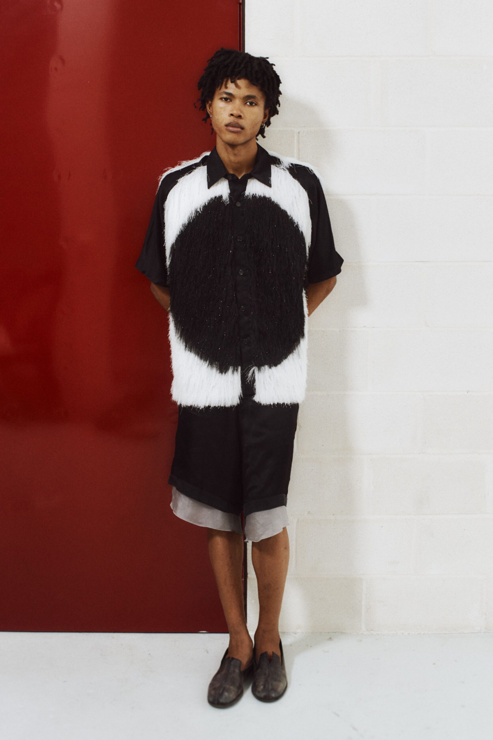 black shirt with fringed vest