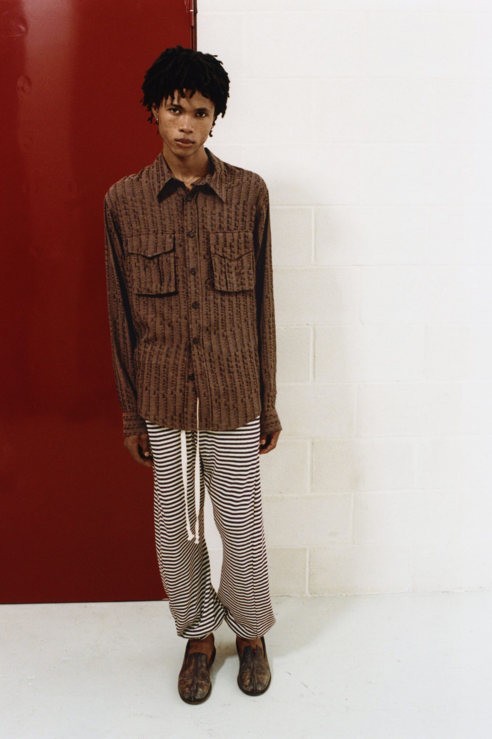 brown printed shirt with striped pants