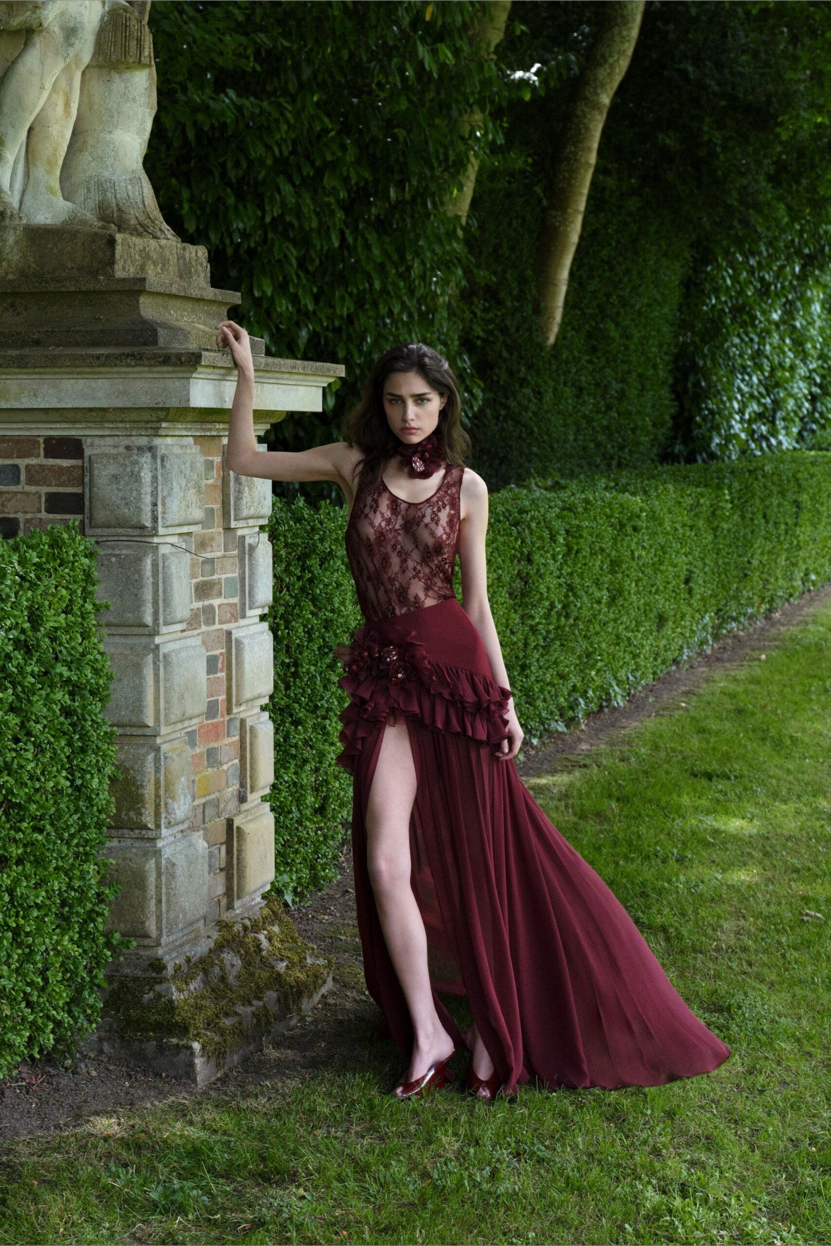 maroon silk sleeveless high-neck fitted ruffled flowing gown