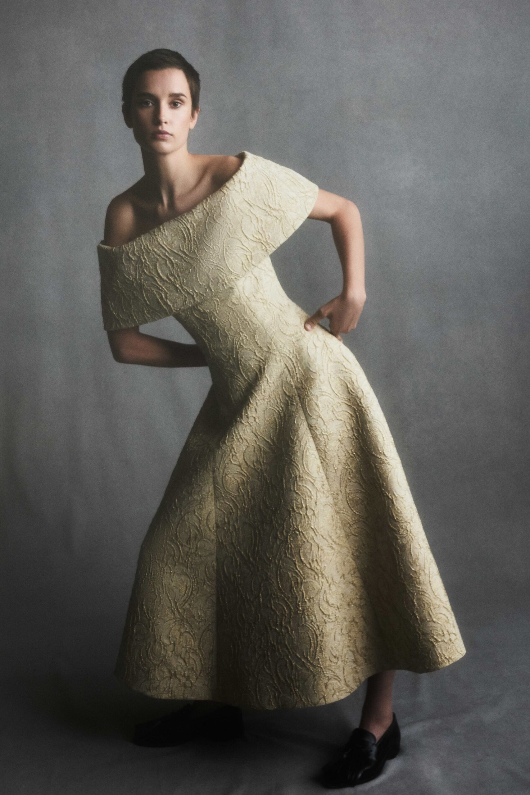 beige silk off-shoulder fitted pleated midi gown