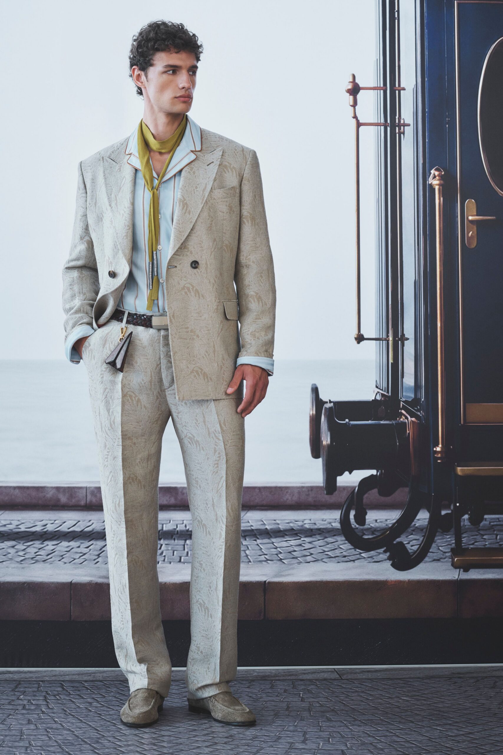 beige tailored suit with blue shirt
