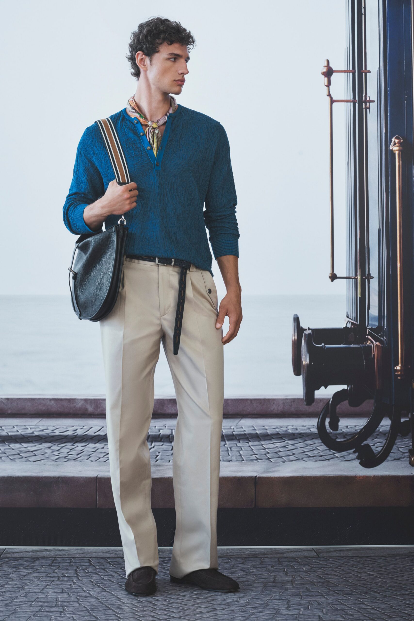 blue relaxed sweater with beige pants