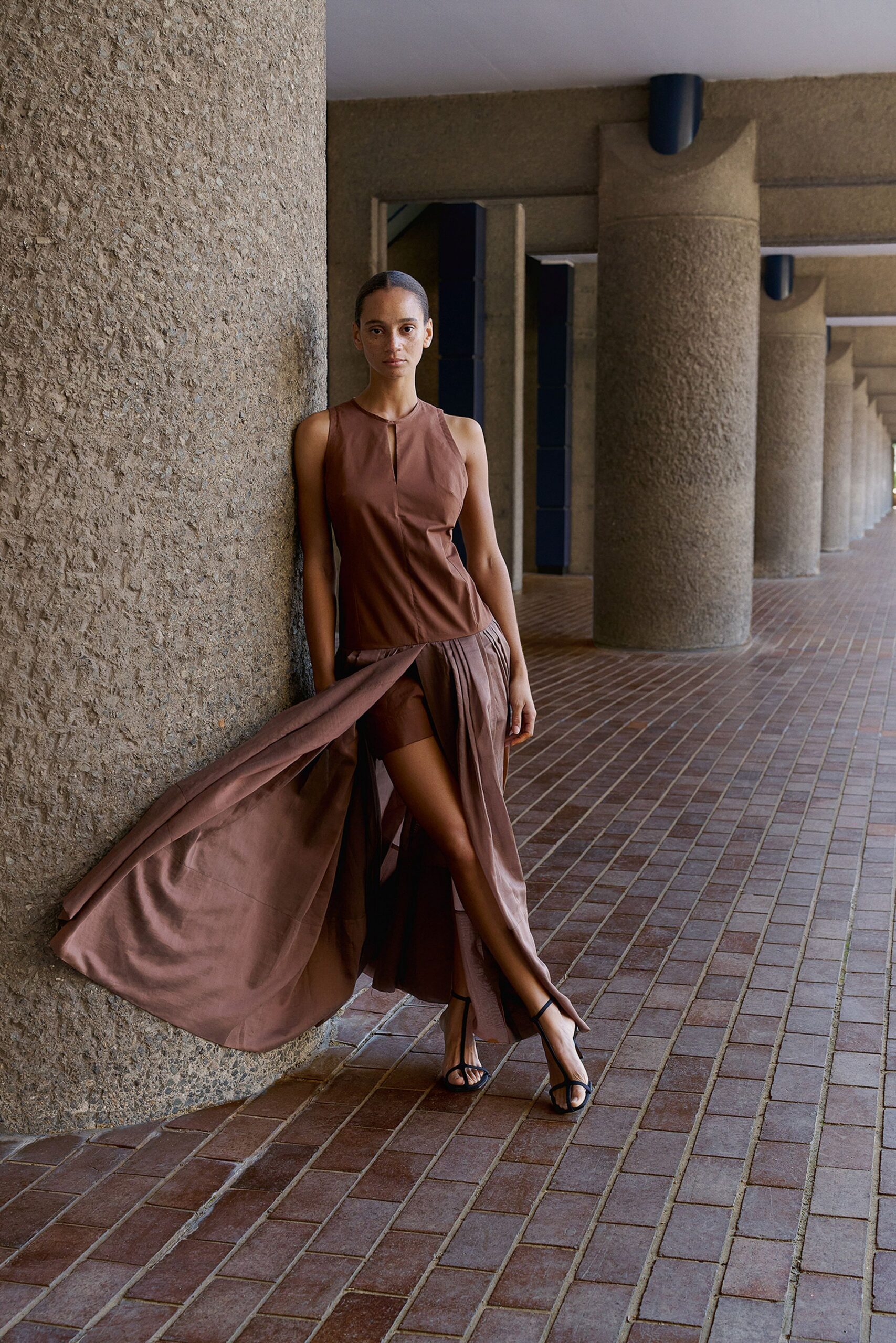 brown silk sleeveless high-neck fitted flowing maxi gown