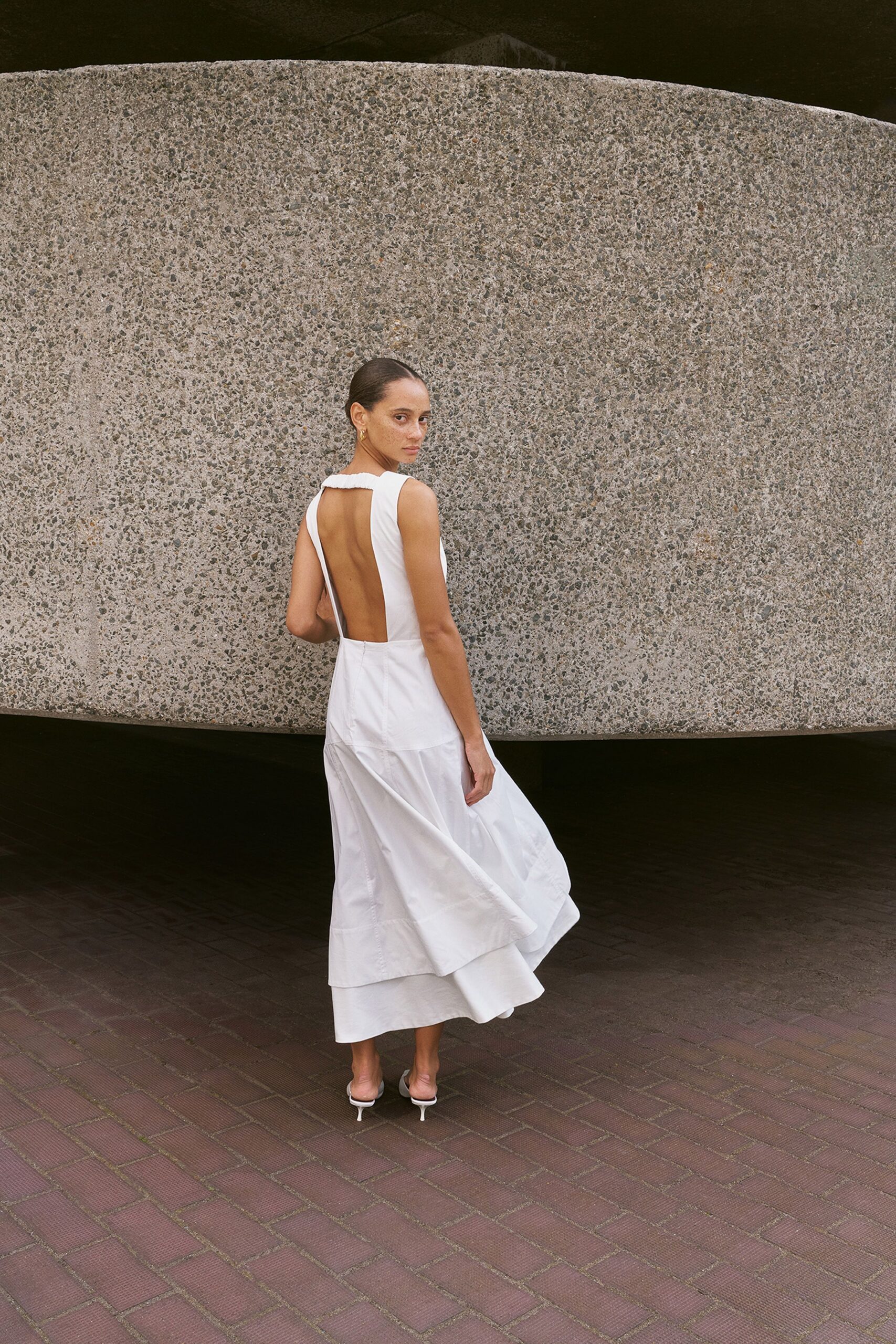 white tiered backless dress with heels