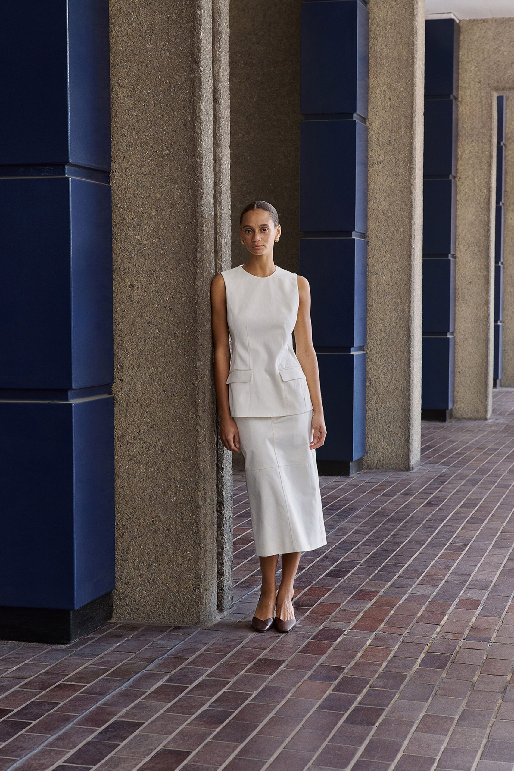 white cotton sleeveless high-neck fitted pleated top