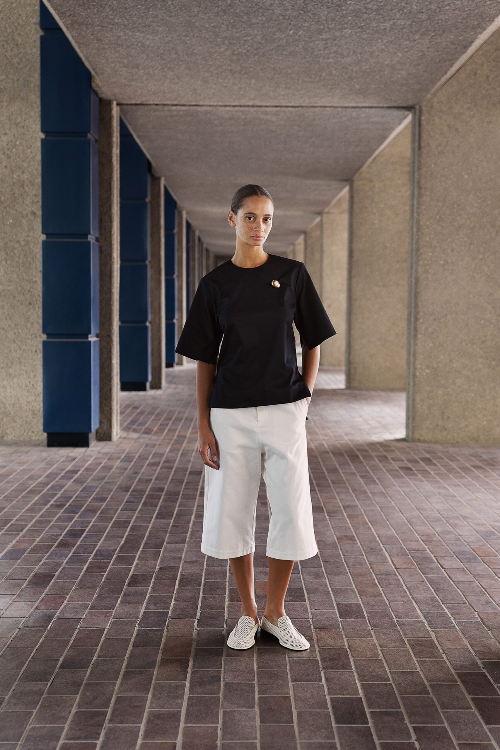 black relaxed top with white pants