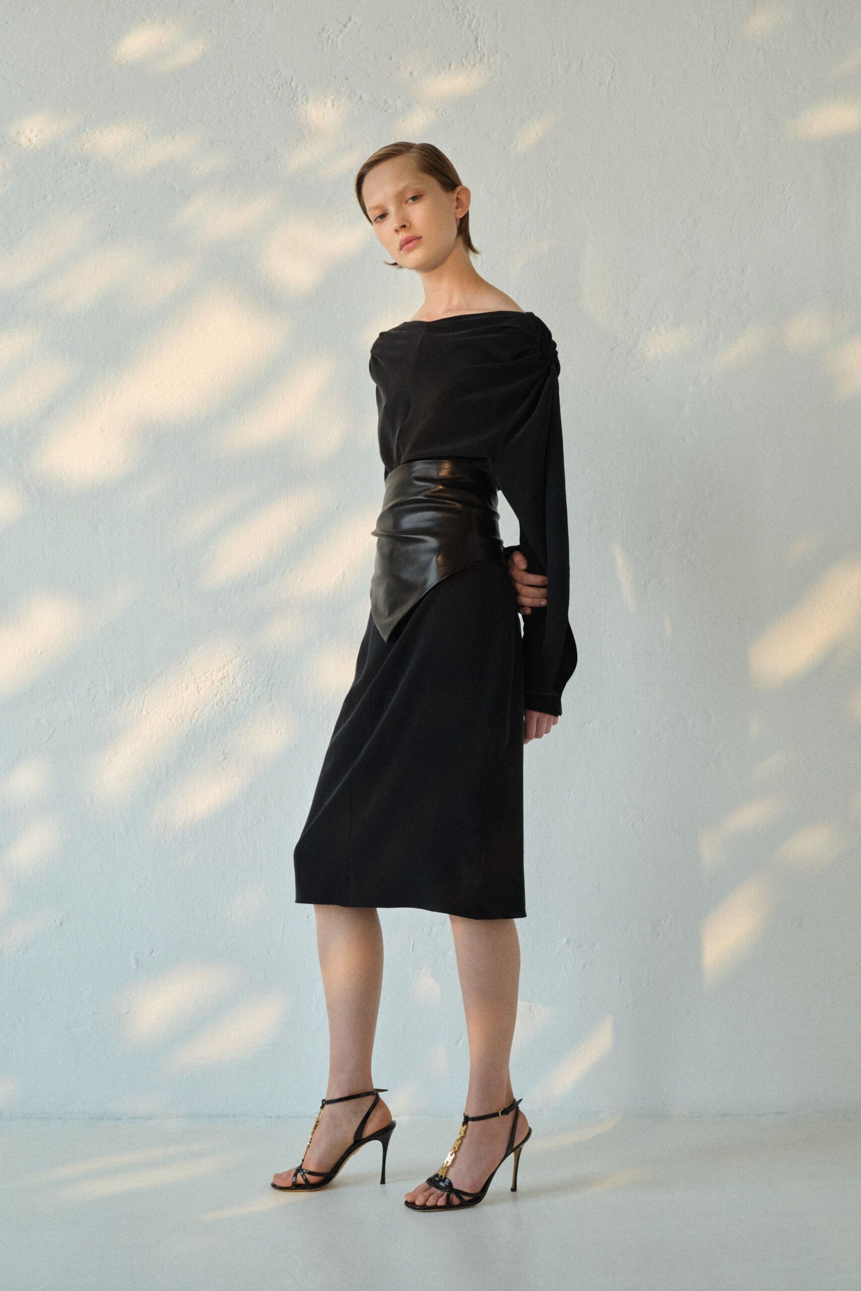 black leather long-sleeve off-shoulder fitted draped midi dress