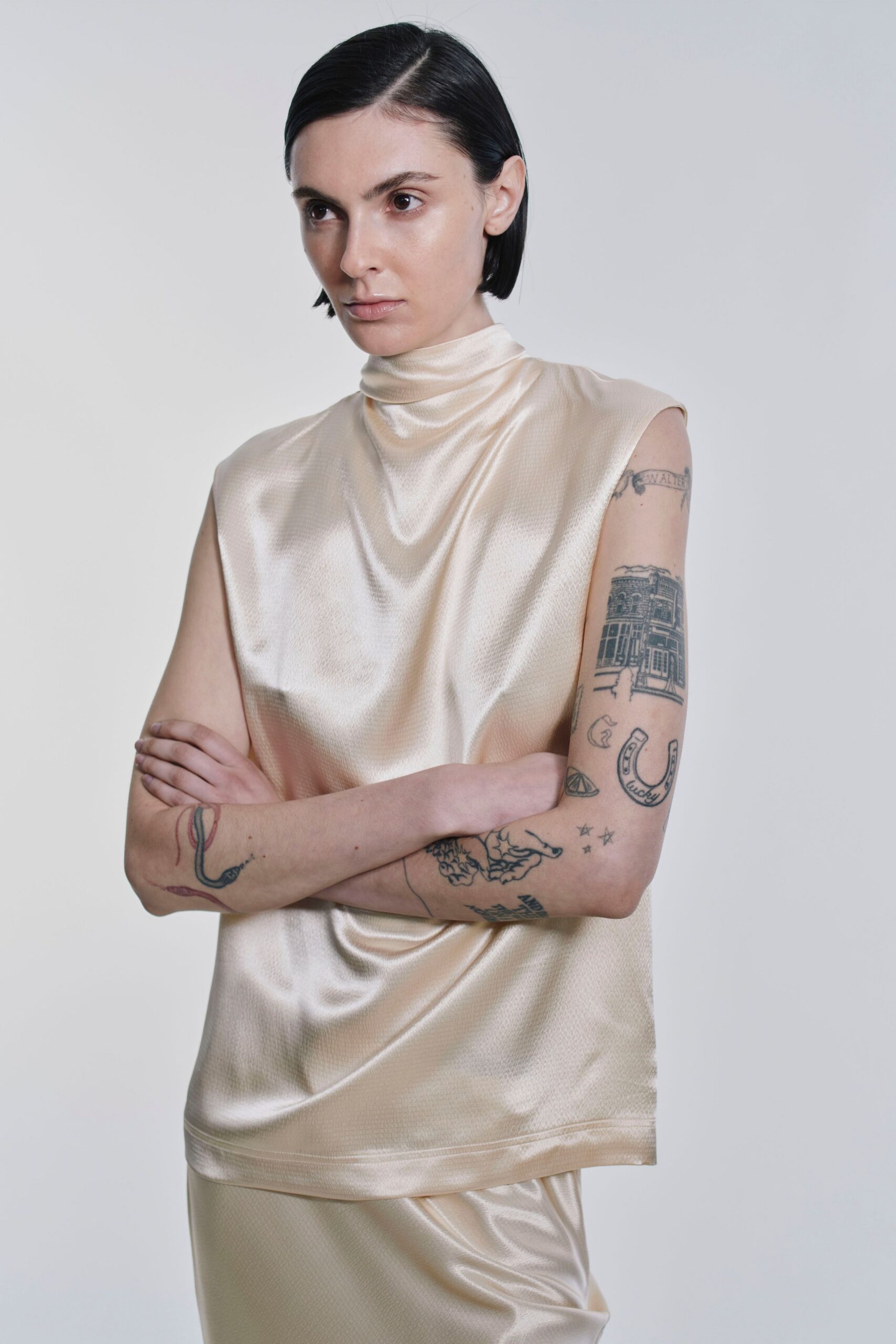 beige silk sleeveless high-neck relaxed draped top