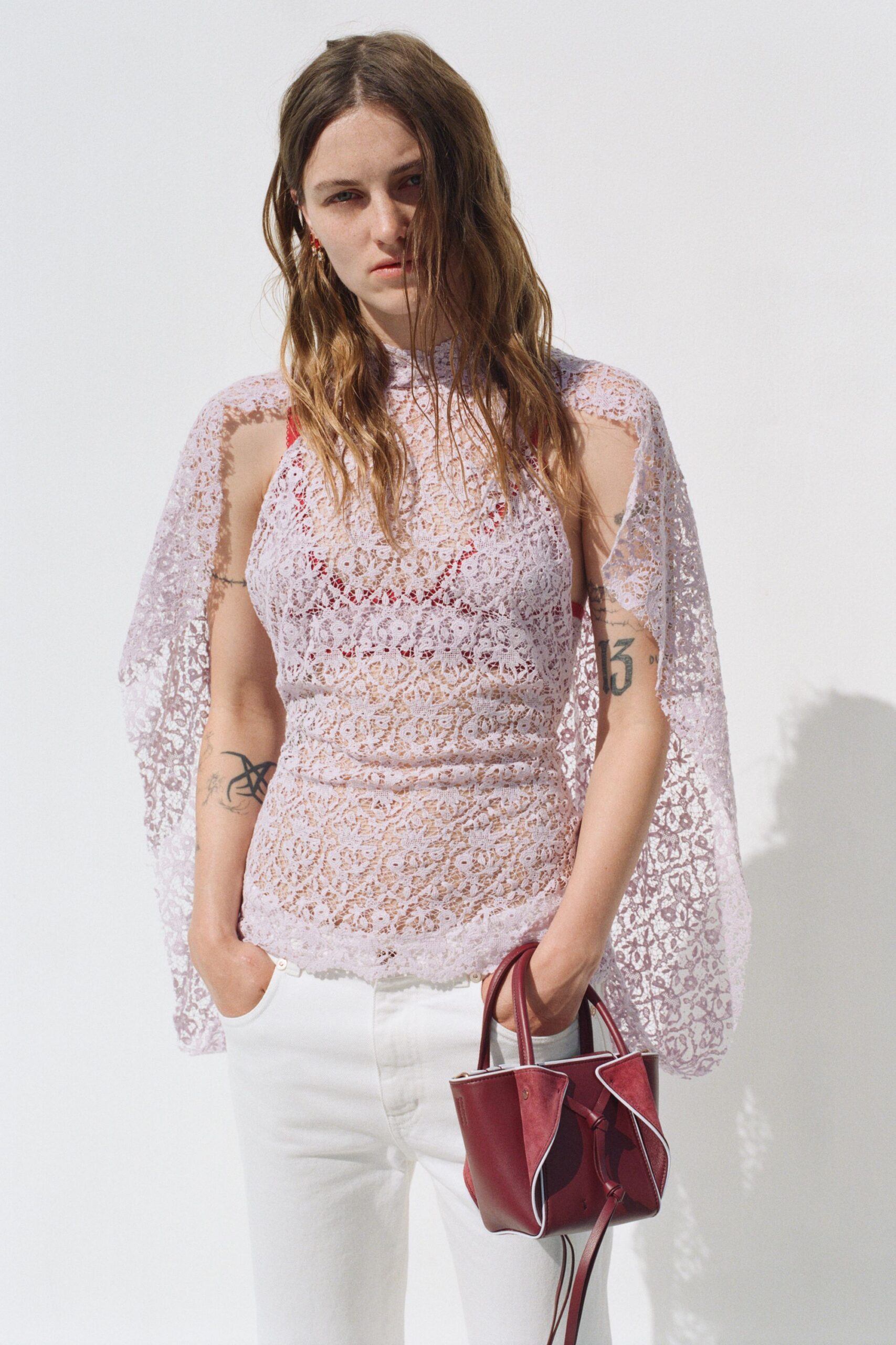 purple lace fitted top with white pants
