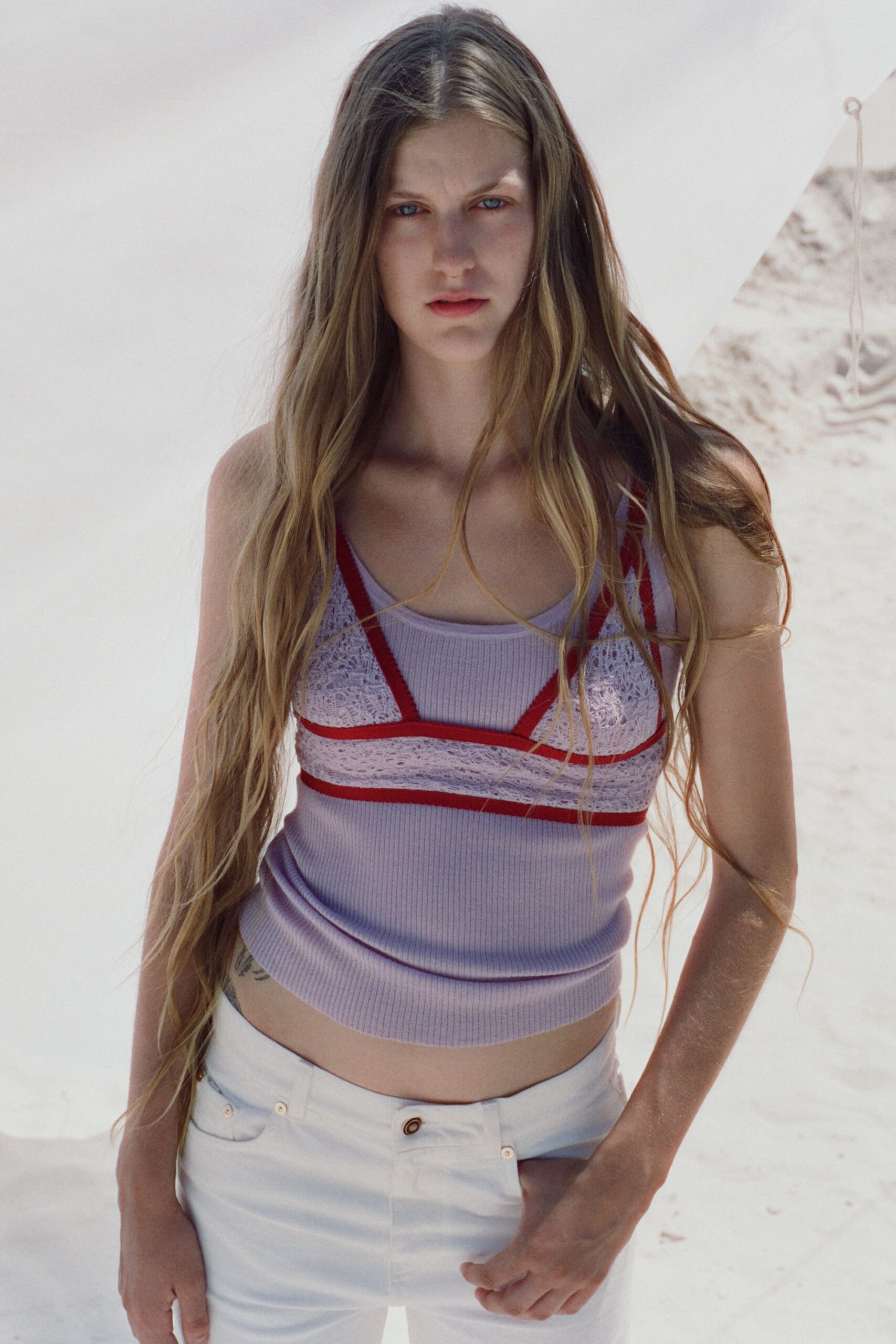 fitted purple and red top with white pants