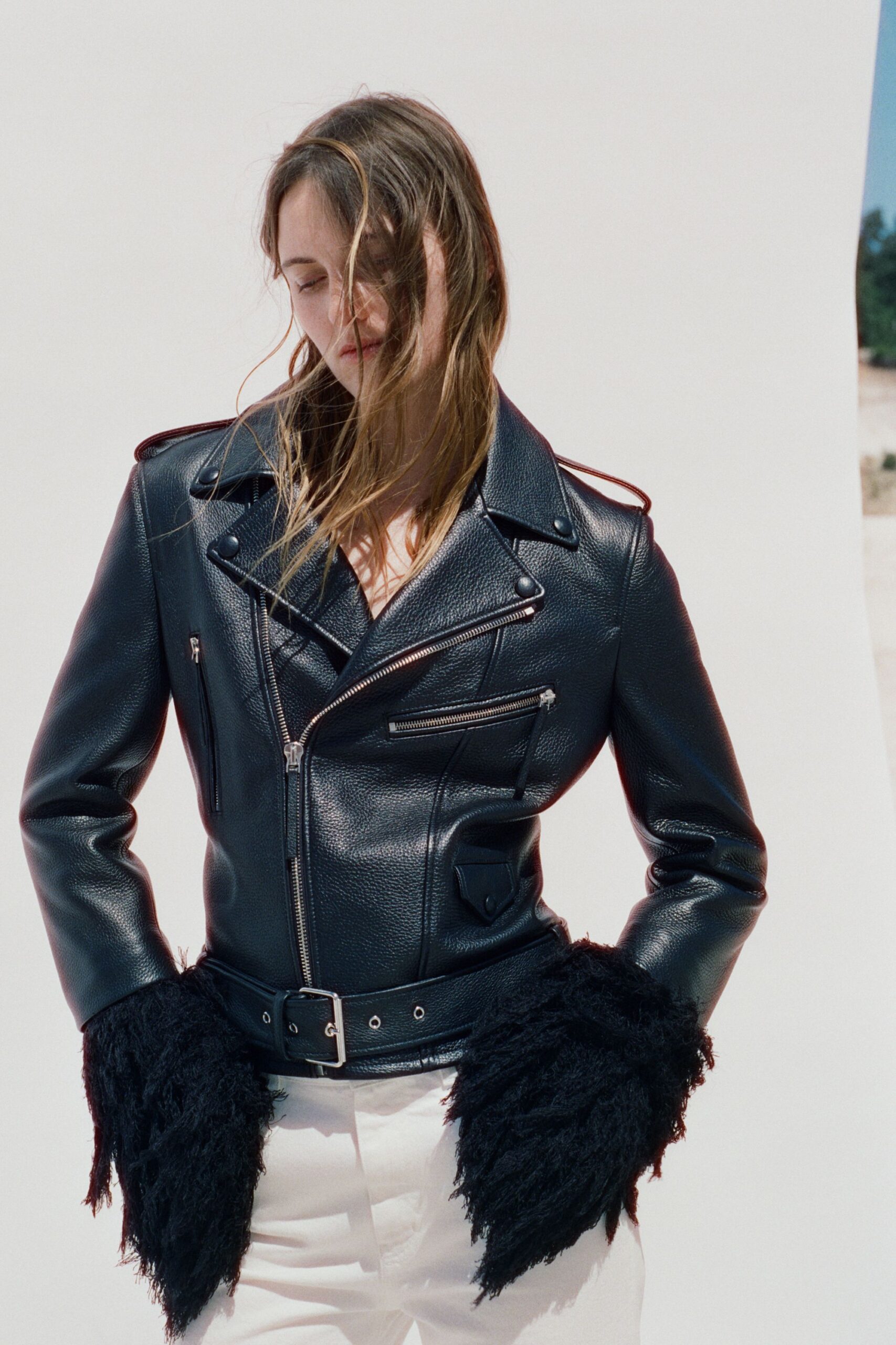 black leather jacket with fringed sleeves