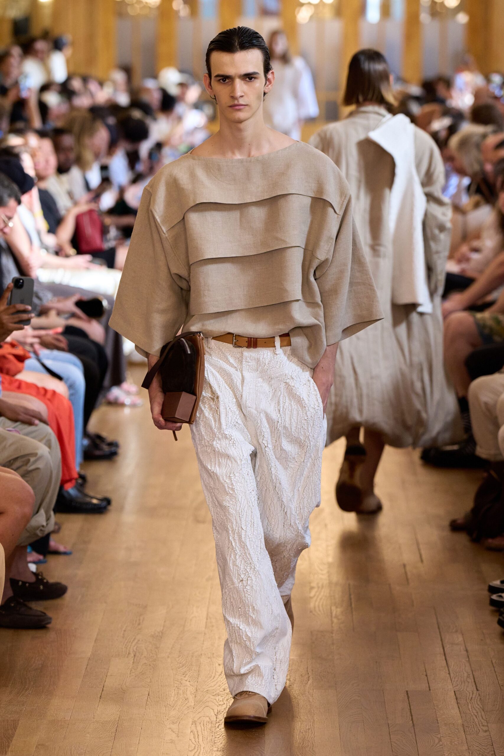 beige layered top with white pants