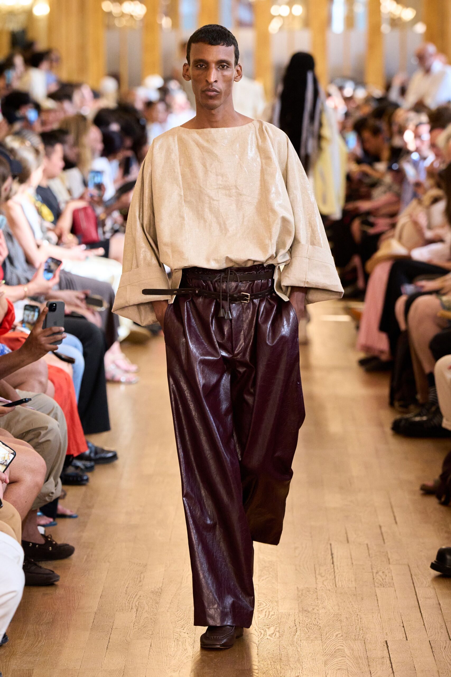 beige linen top with maroon leather pants